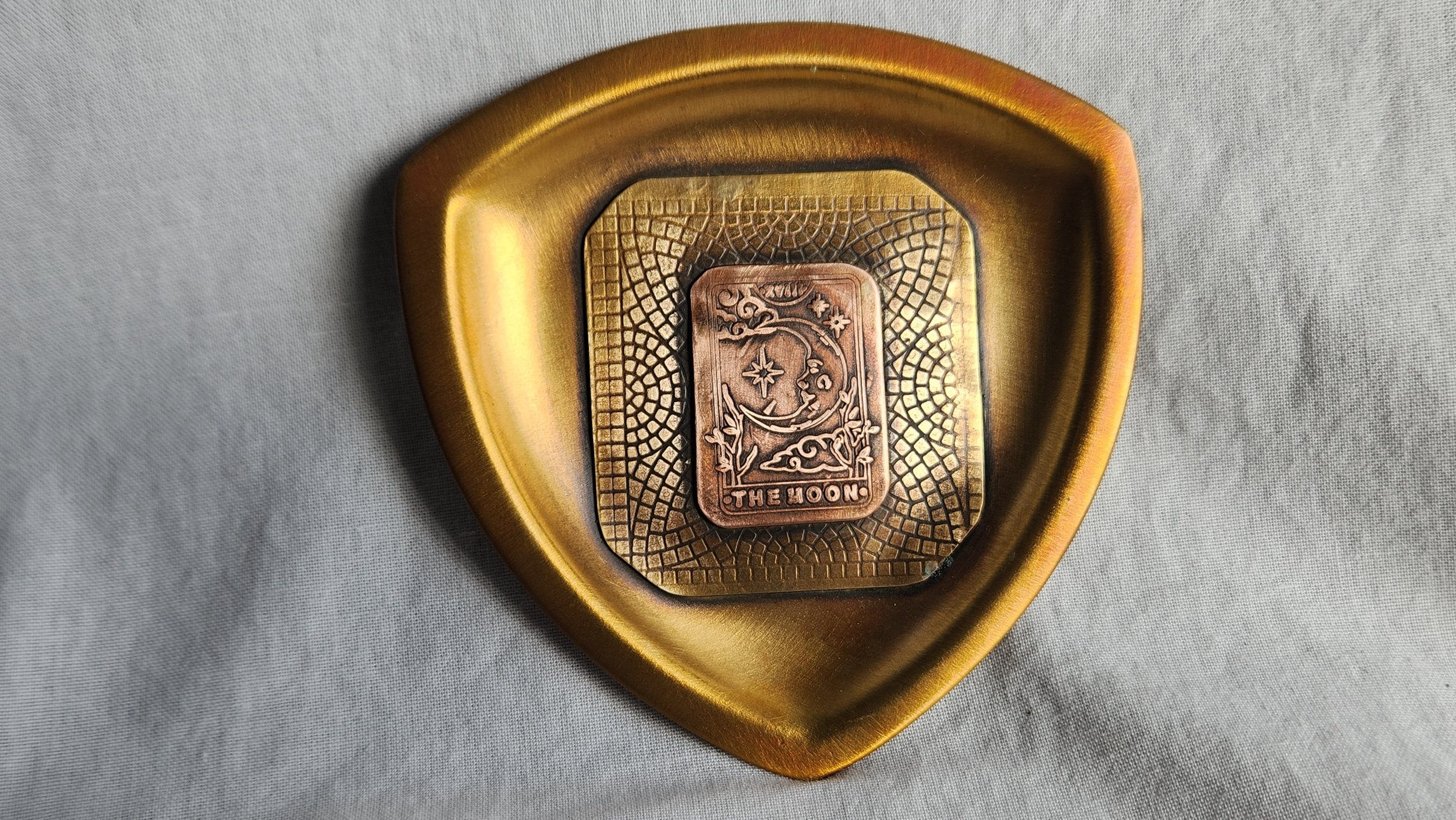 Trillion shaped brass dish with die struck moon tarot card motif.