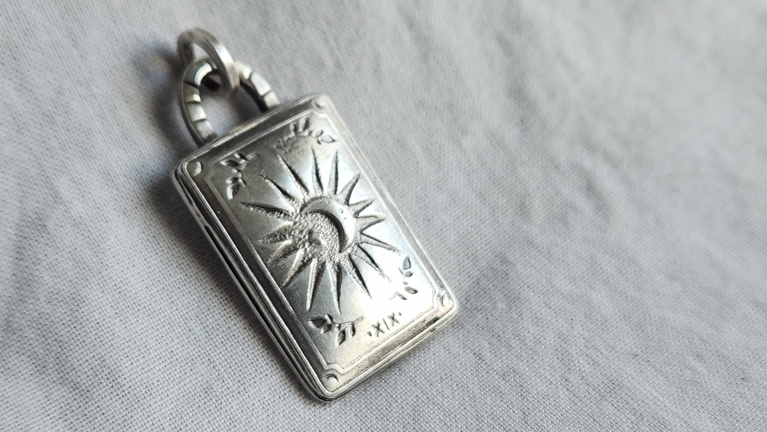 Die-struck sterling silver necklace with sun star tarot card.