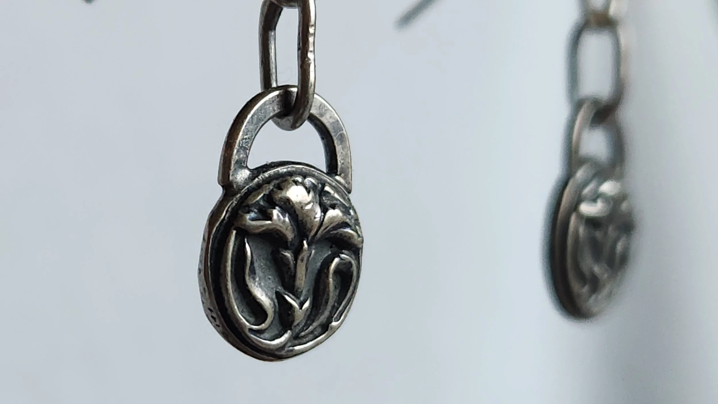 Die-struck and hand fabricated sterling silver French carnation drop earrings.