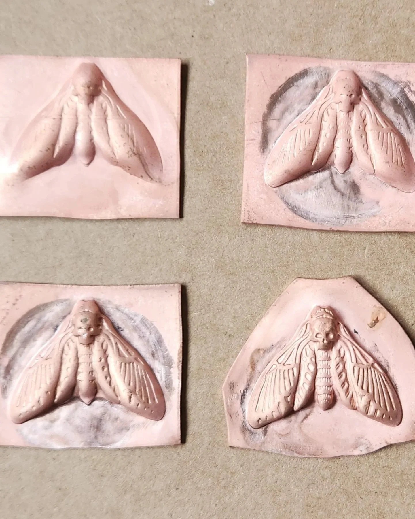 Demonstration of the progressive nature of die striking: four copper squares at various stages in the die striking process.