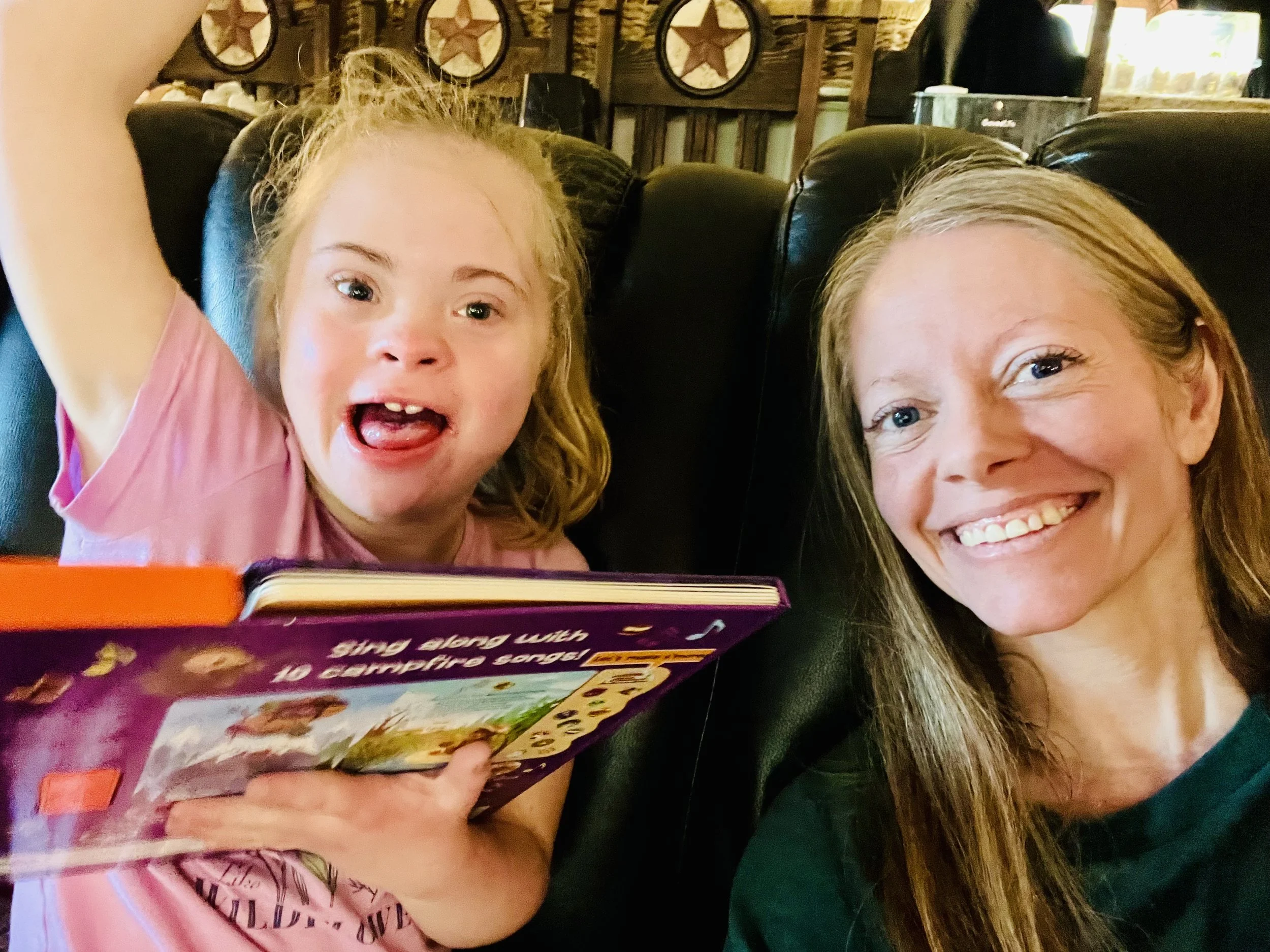 A person holding a modern, minimalist ceramic vase with a gradient from dark gray at the top to white at the bottom, textured and ribbed on the lower half.