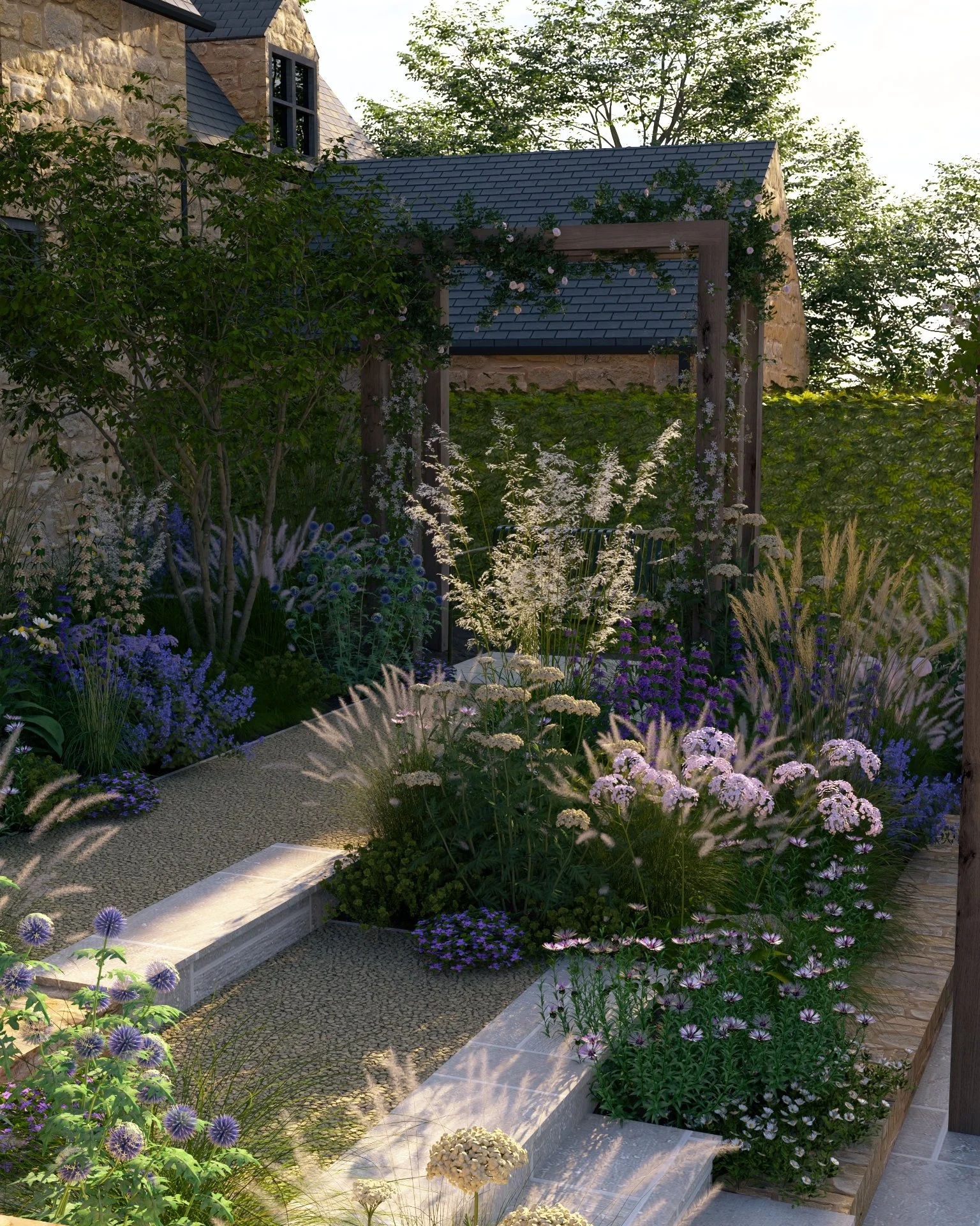 A lush garden with a stone pathway, colorful flowers and perennial grasses, and a wooden pergola against a Cotswold stone house, surrounded by trees and greenery.