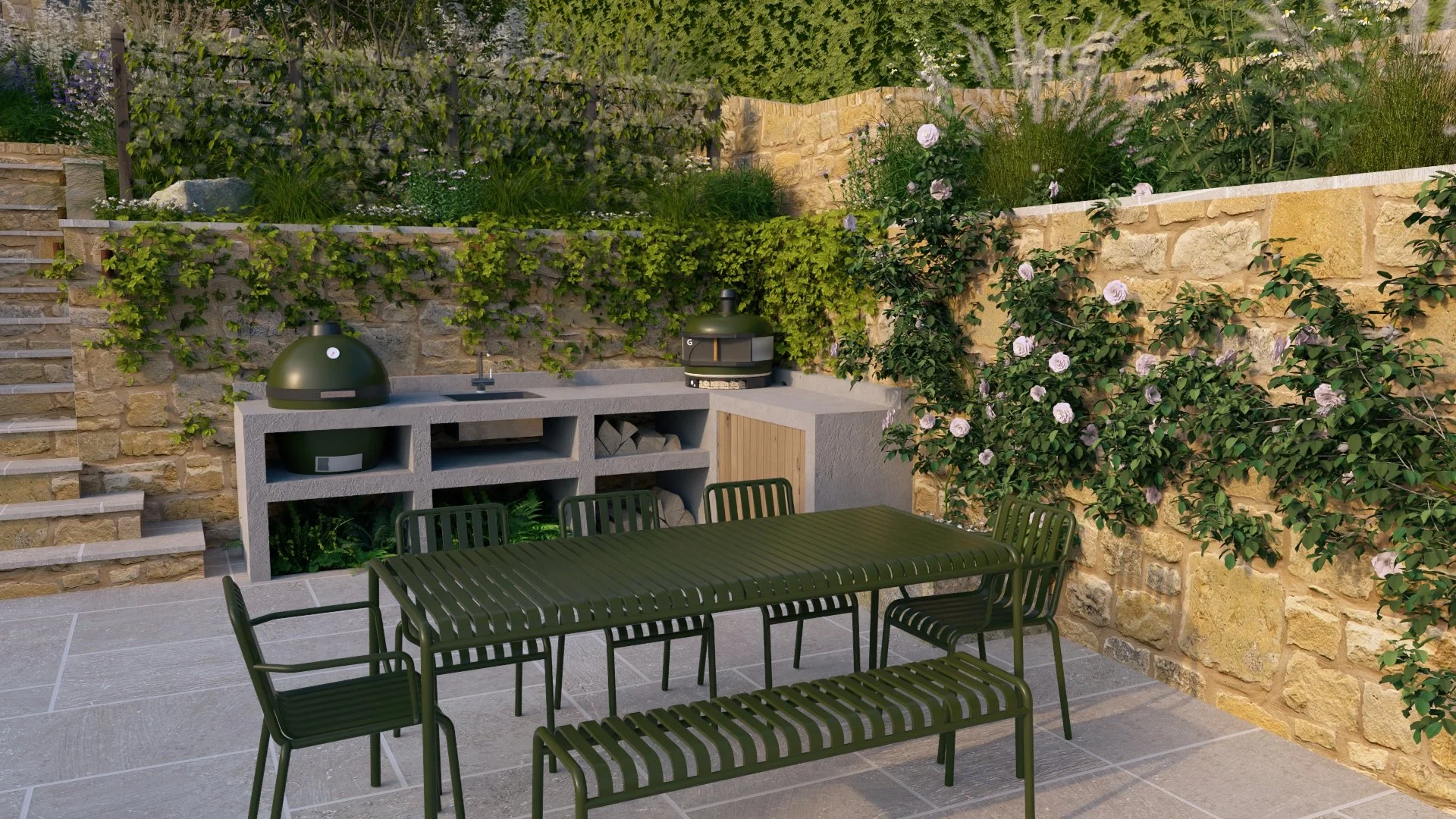 Outdoor kitchen with HAY Palissade long green metal dining table and chairs, a built-in Big Green Egg grill, outdoor sink and Gozney pizza oven, stone retaining walls climbing plants and roses, timber and metal balustrade and espalier fruit trees