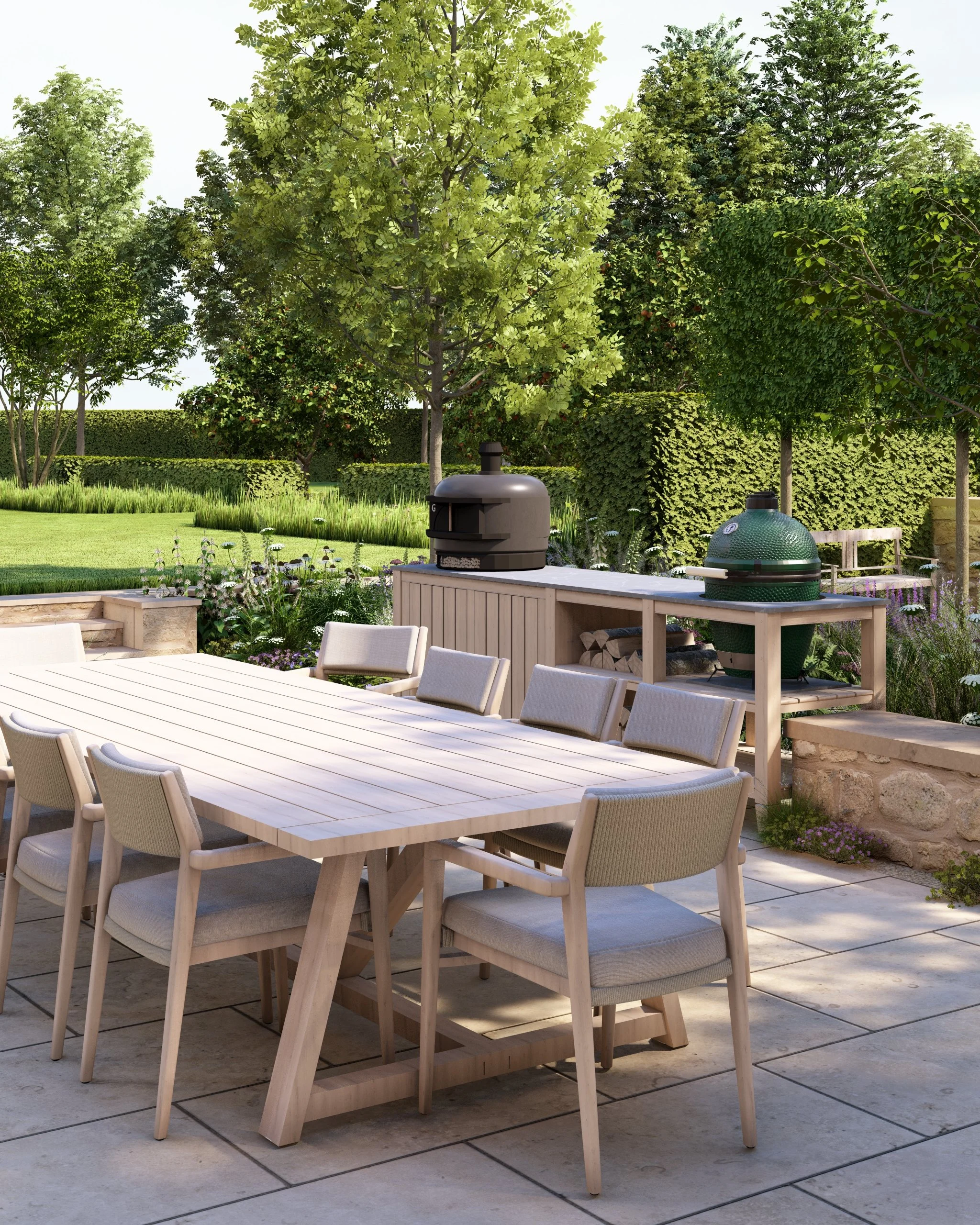 Outdoor patio/terrace and kitchen with a built-in Big Green Egg grill and Gozney pizza oven, a long wooden table and chairs, limestone benches beyond that, steps up to a manicured lawn with sections of wildflowers