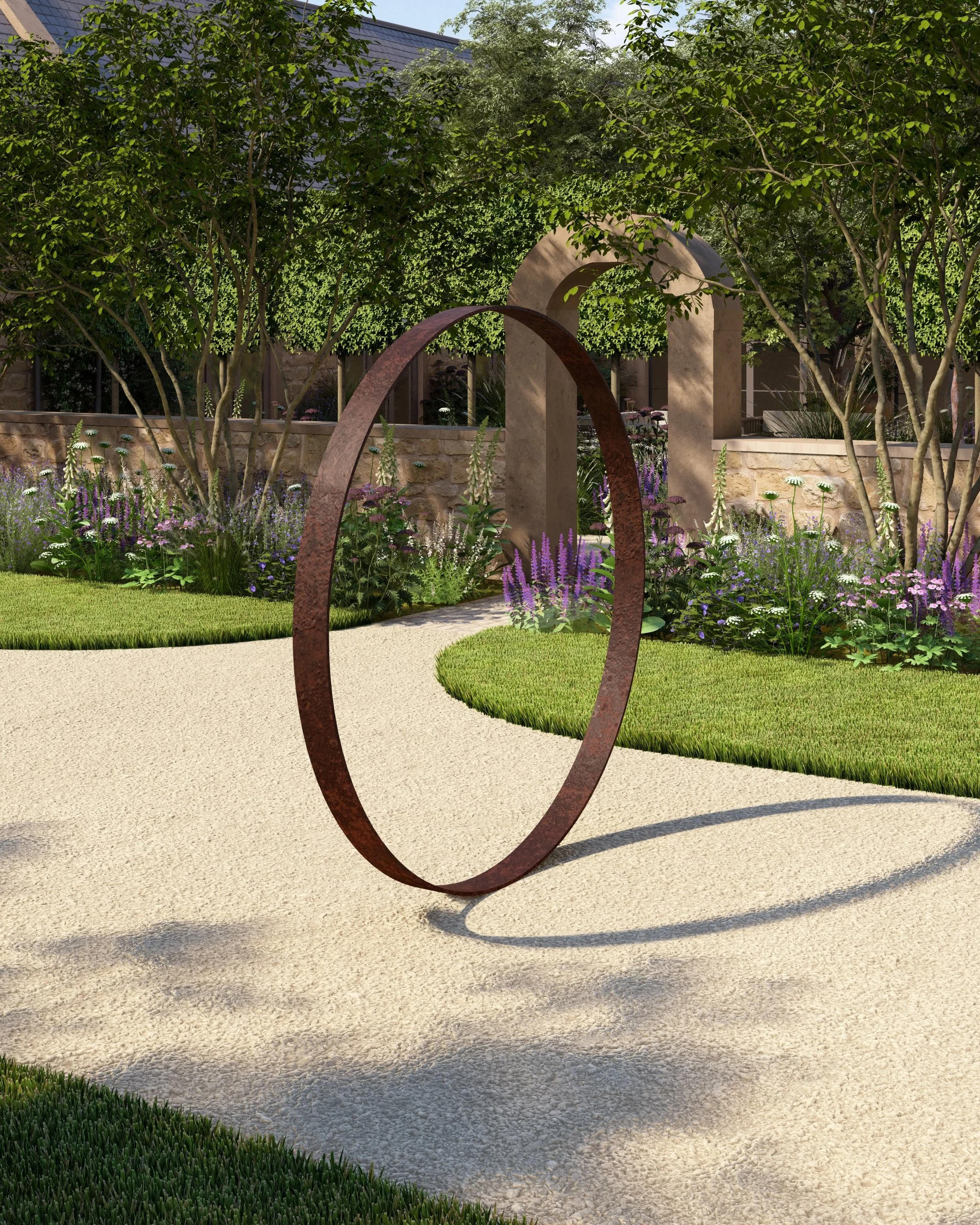 A contemporary Cotswold garden design with a Corten steel ring sculptural focus point set on the gravel, a stone archway in the background, naturalistic planting