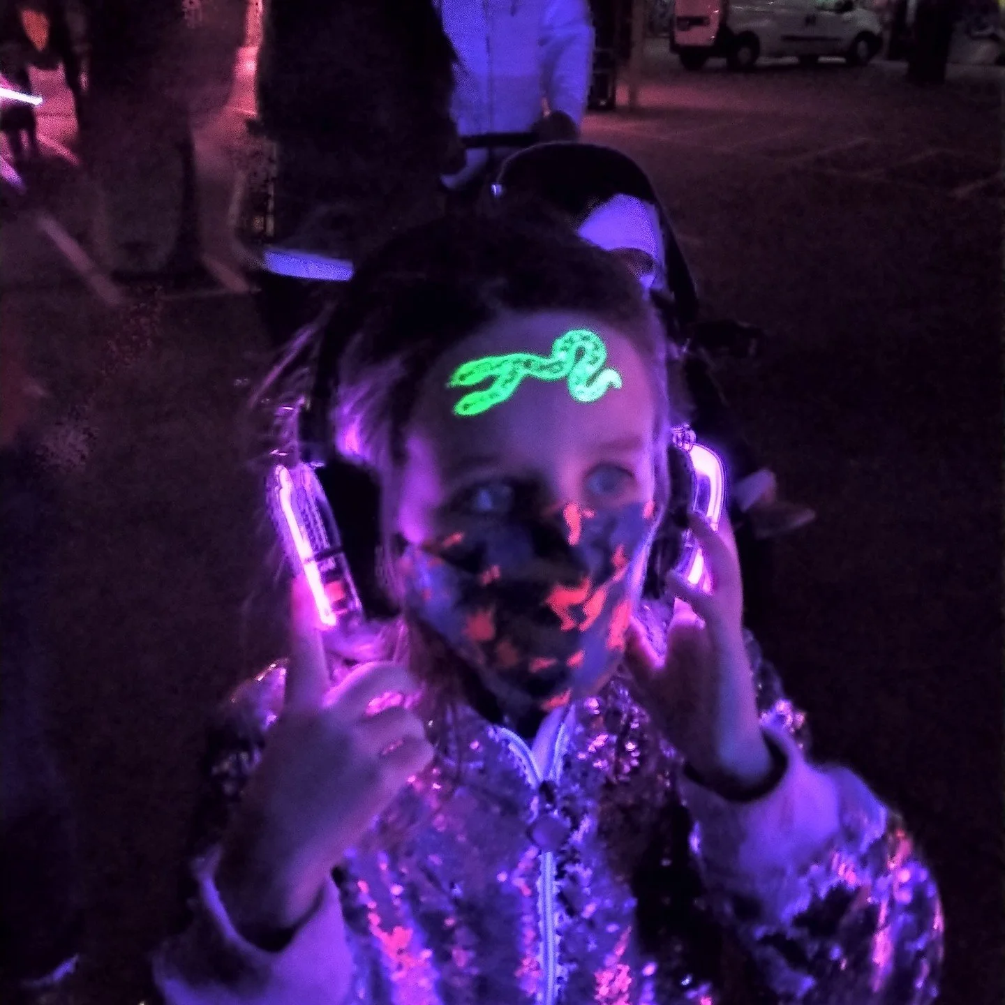 Hazel was living her best life #pdxlightfest Silent Disco and getting painted into a glow-in-the-dark group portrait by media artist Kendall Cottrell.
