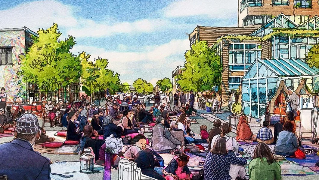 Outdoor market or festival with people sitting on mats, green trees, glass buildings, and a blue sky.