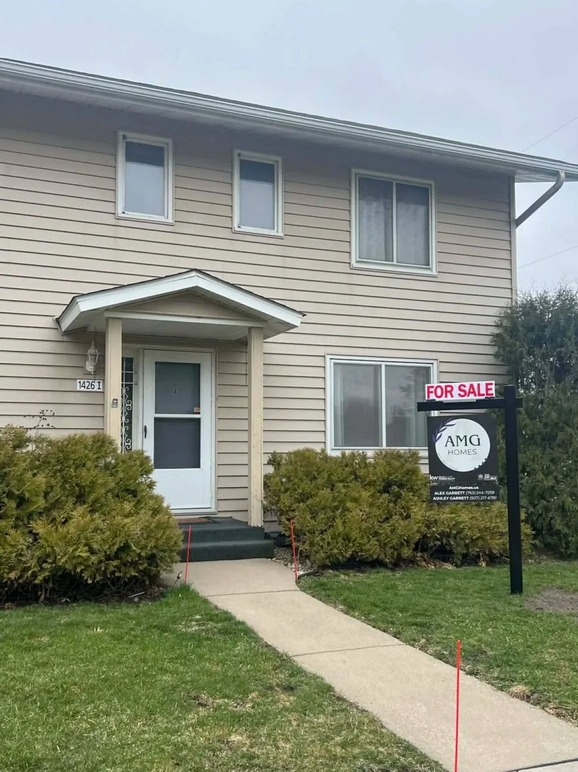 AMG Homes sign in front of a home that is for sale.