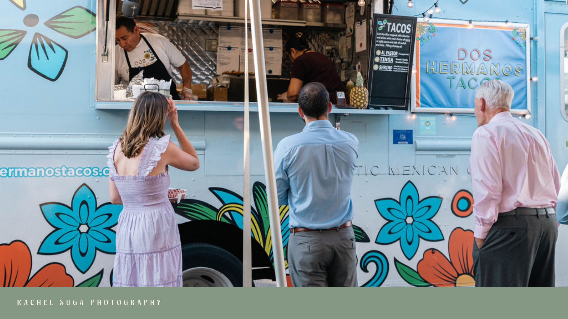 People ordering food at a colorful food truck named 'Dos Hermanos Tacos' with a menu board and two workers inside preparing food.