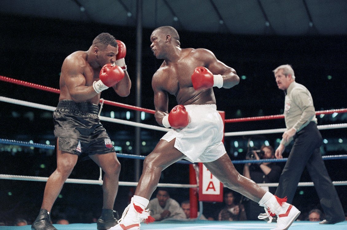 Buster Douglas throws punches at Mike Tyson in their fight