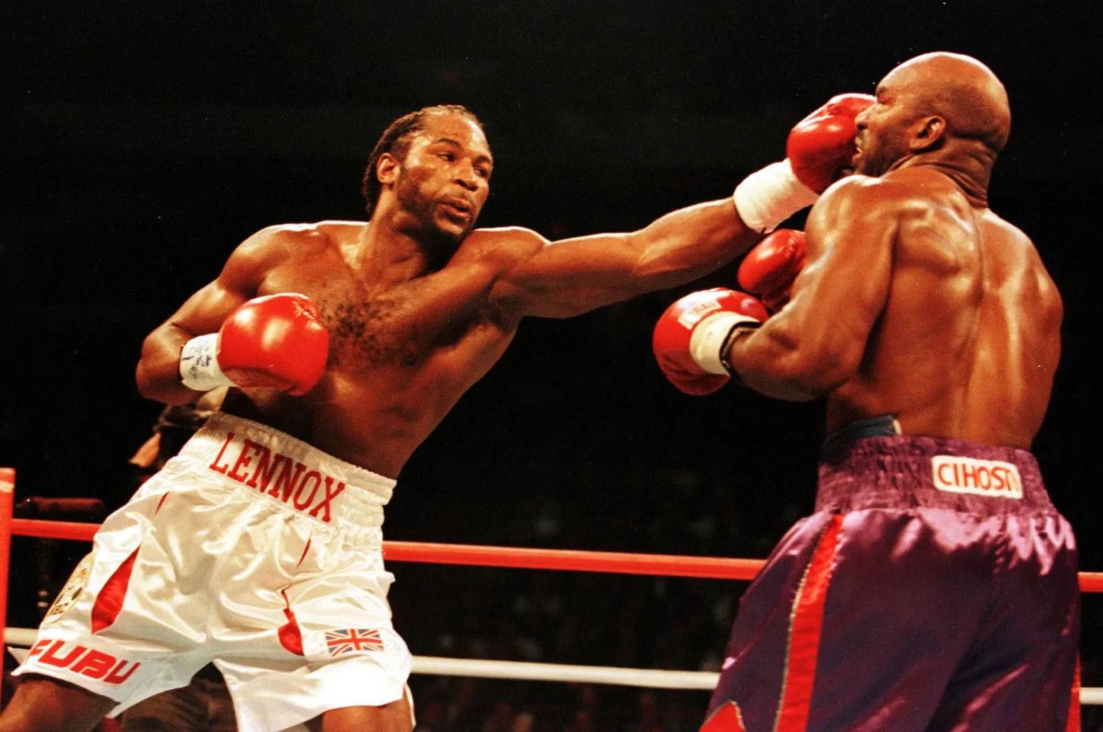 Lennox Lewis throws a jab at Evander Holyfield in their first fight in 1999