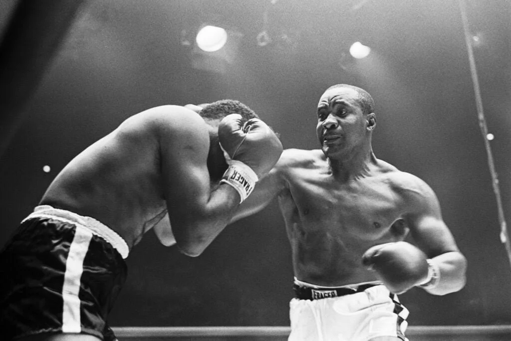 Sonny Liston lands a punch on Floyd Patterson, black and white