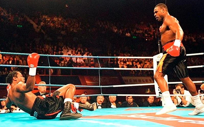 Oliver McCall knocks down Lennox Lewis in round 2 of their first fight