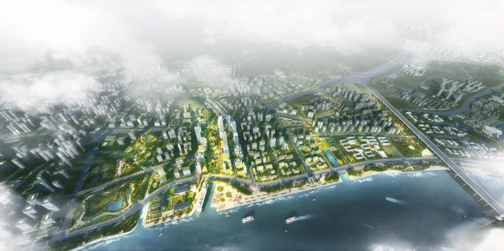 Aerial view of a city waterfront with modern buildings, green parks, bridges, and boats on the water.