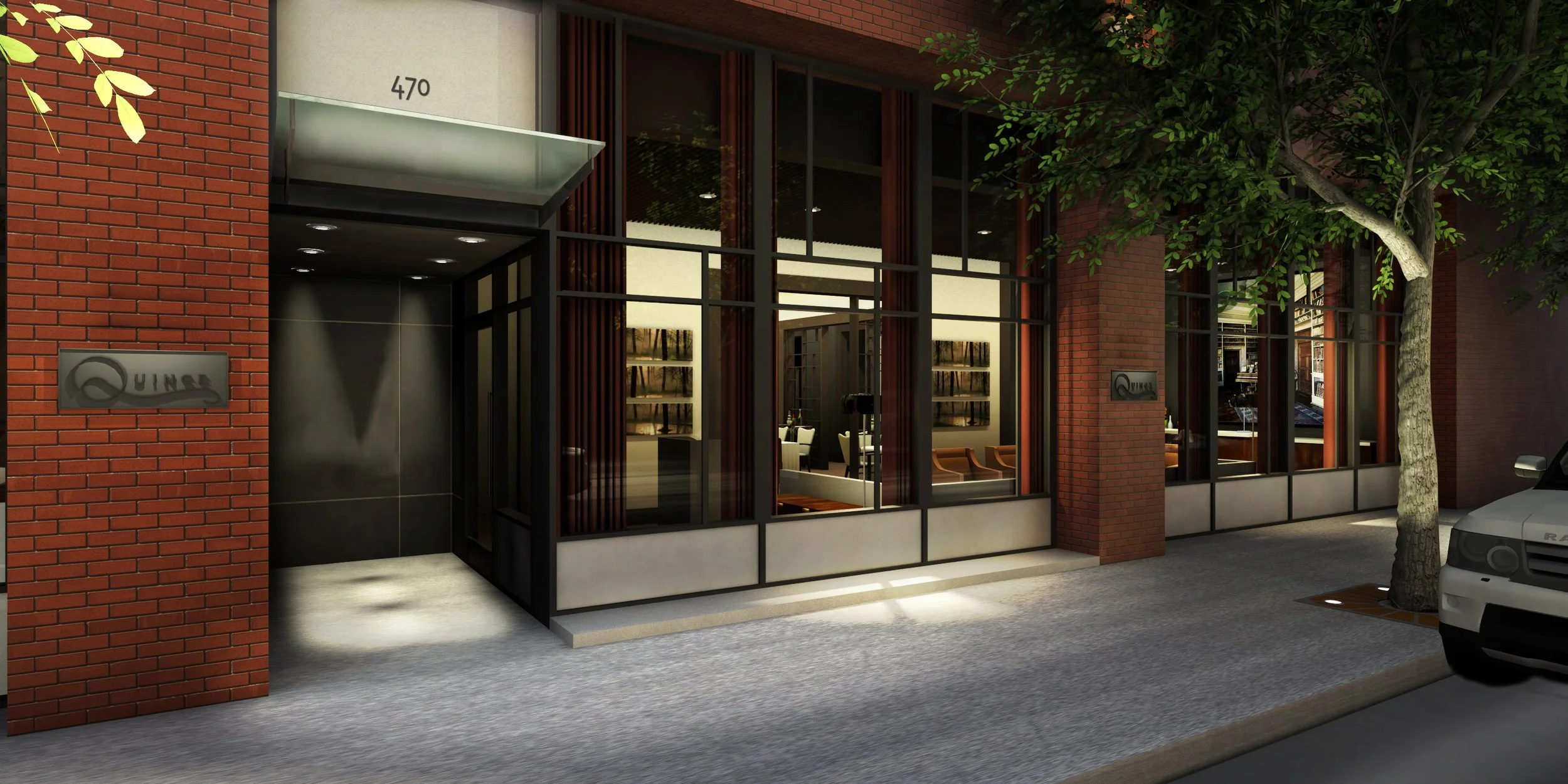 Exterior view of a modern building with large glass windows, brick walls, and a tree on the sidewalk. There is a sign on the wall that reads 'Quinn'. Inside, the lobby features seating and artwork.