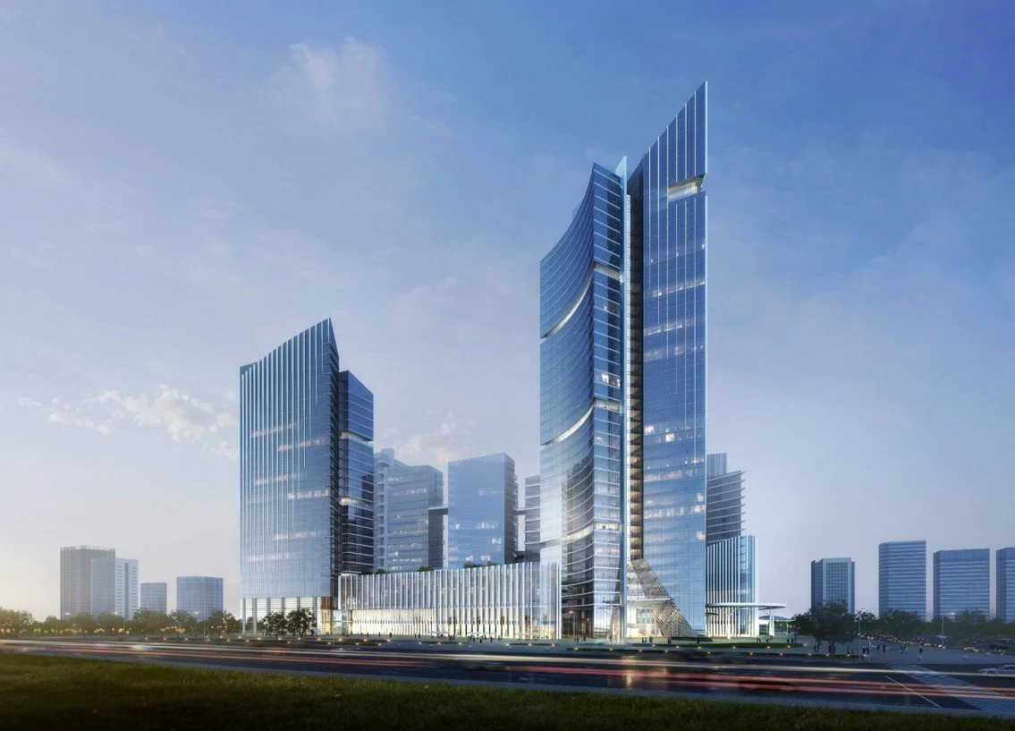 A modern glass skyscraper with a curved design in an urban cityscape under a partly cloudy sky.