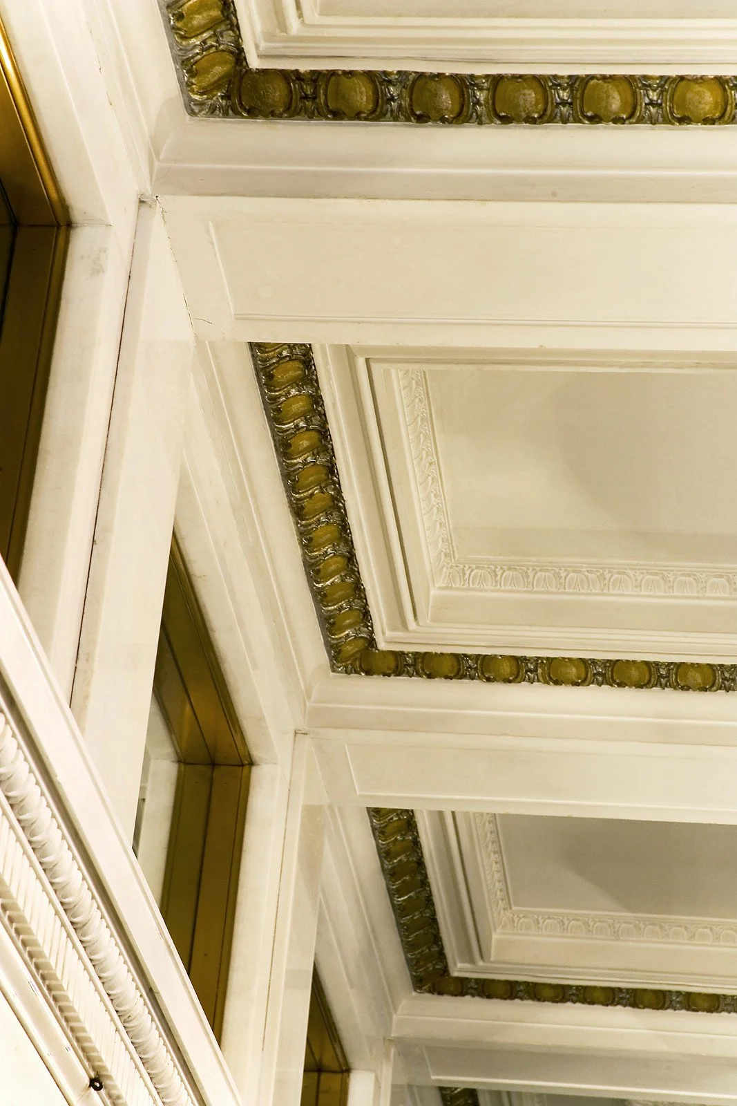Close-up of ornate ceiling with decorative molding and gold accents