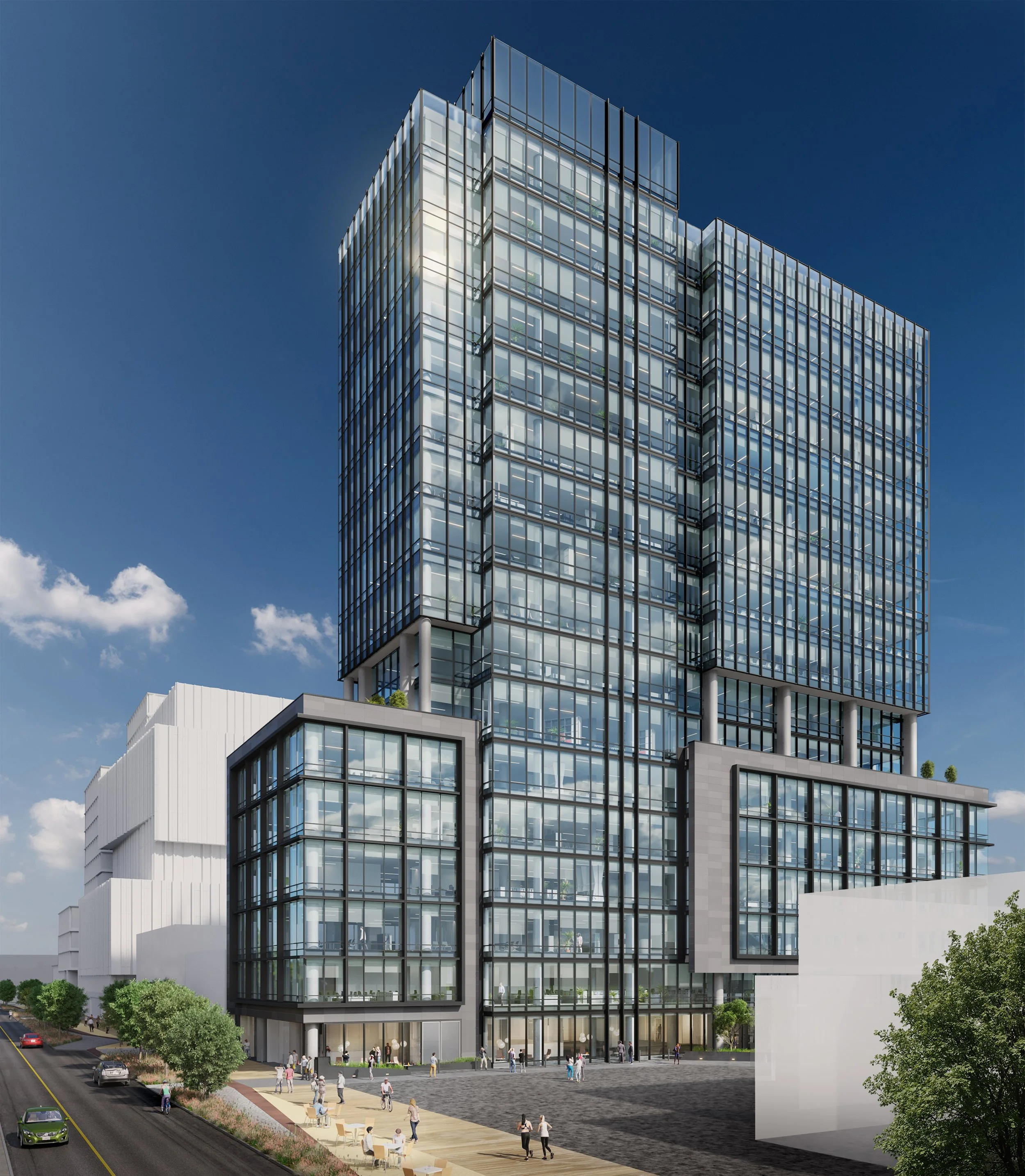 Modern glass high-rise building with multiple floors and architectural design, with people walking and sitting outside.