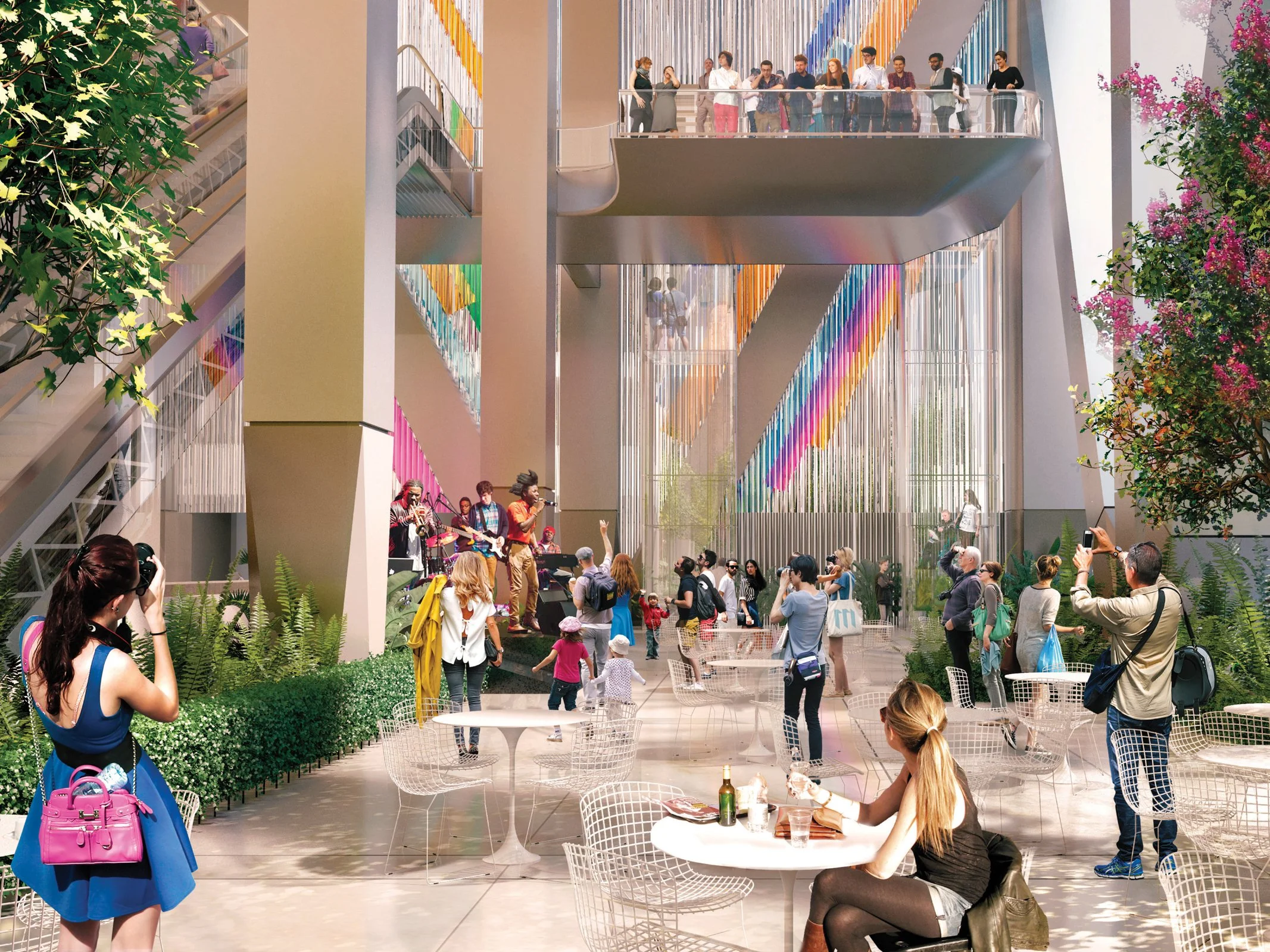 A lively indoor space with people watching a live musical performance, taking photos, and socializing. The area features modern architecture with colorful geometric decorations on the walls and glass railings, along with tables, chairs, and greenery.