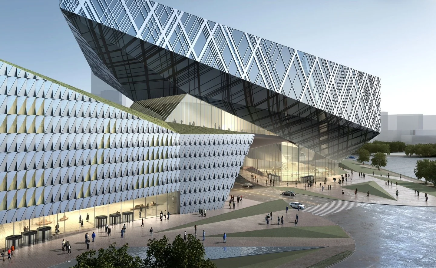 Modern architectural building with glass and metal facades near water, with pedestrians walking along the promenade.