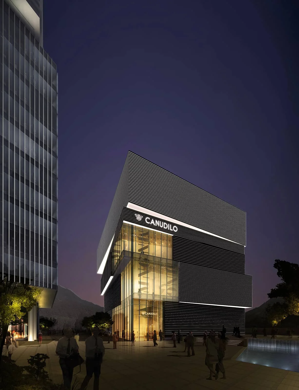 Nighttime view of a modern commercial building with illuminated signage reading 'CANUDILO'. The building features glass and metal exterior with bright interior lighting visible through large windows. People are walking around the plaza in front of th