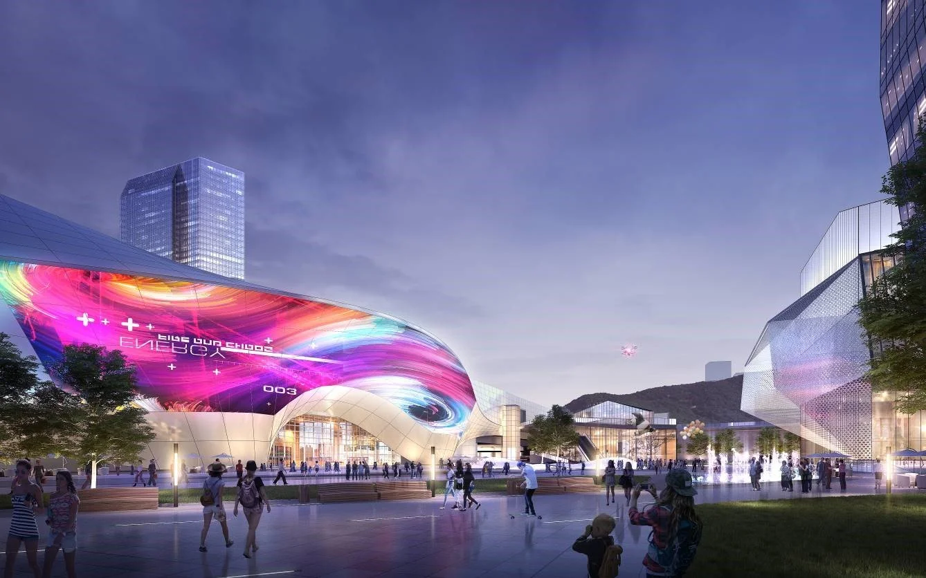 Futuristic cityscape at dusk with modern glass buildings, colorful digital art projected on a curved structure, and people walking in a plaza.