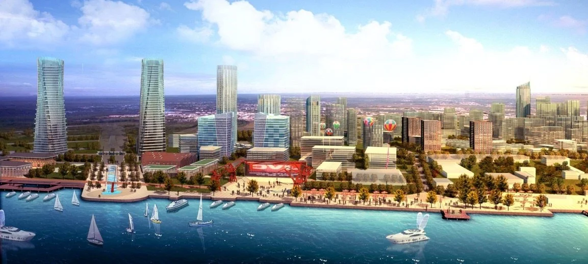 A cityscape featuring modern high-rise buildings along a waterfront with sailboats and yachts, green trees, and a promenade.