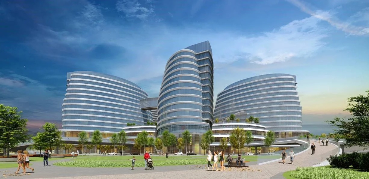 Modern multi-story medical or office building with curved glass exterior and landscaped surroundings