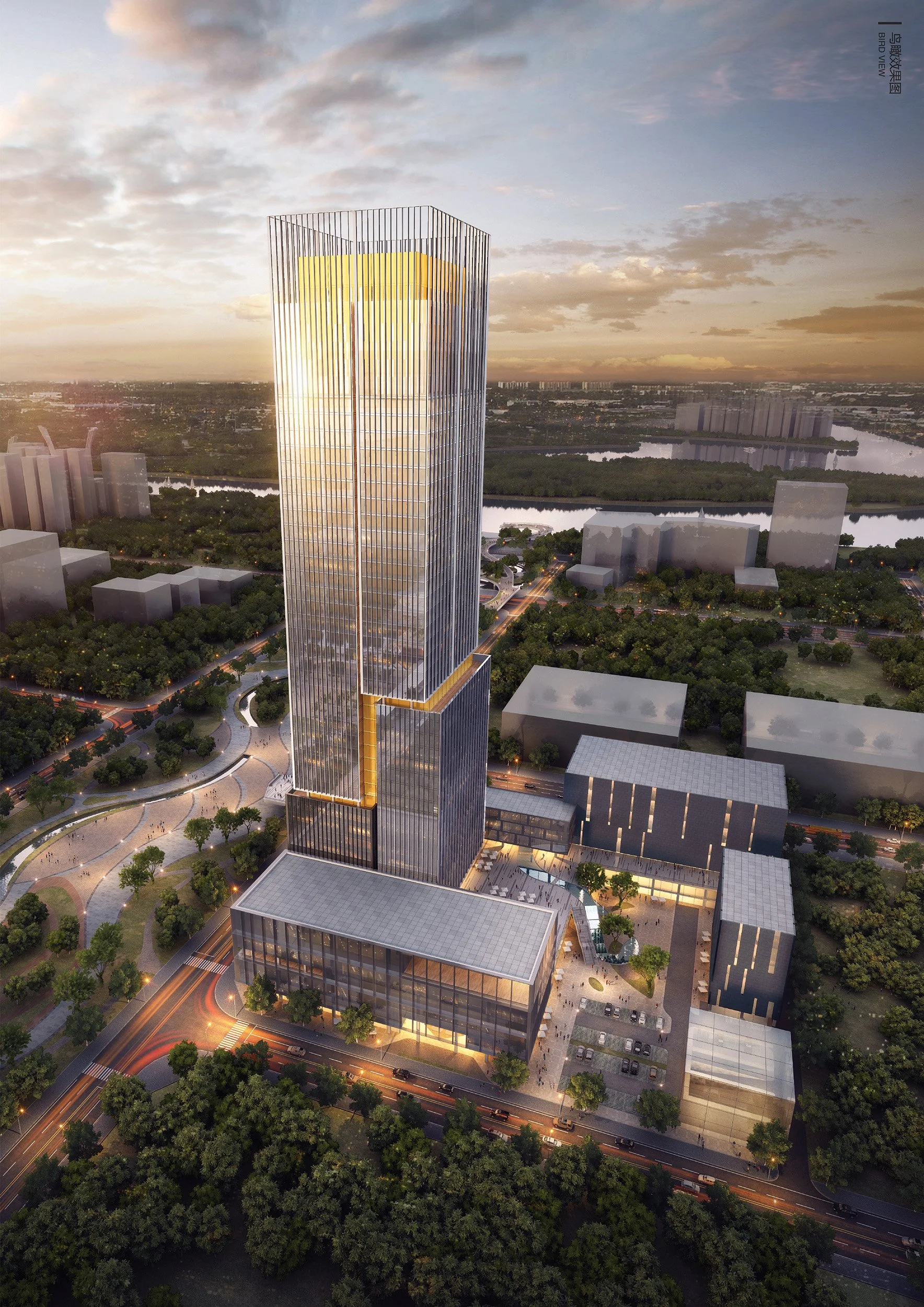 An aerial view of a tall modern skyscraper with a unique golden accent design, surrounded by green parks, roads, and smaller buildings during sunset.