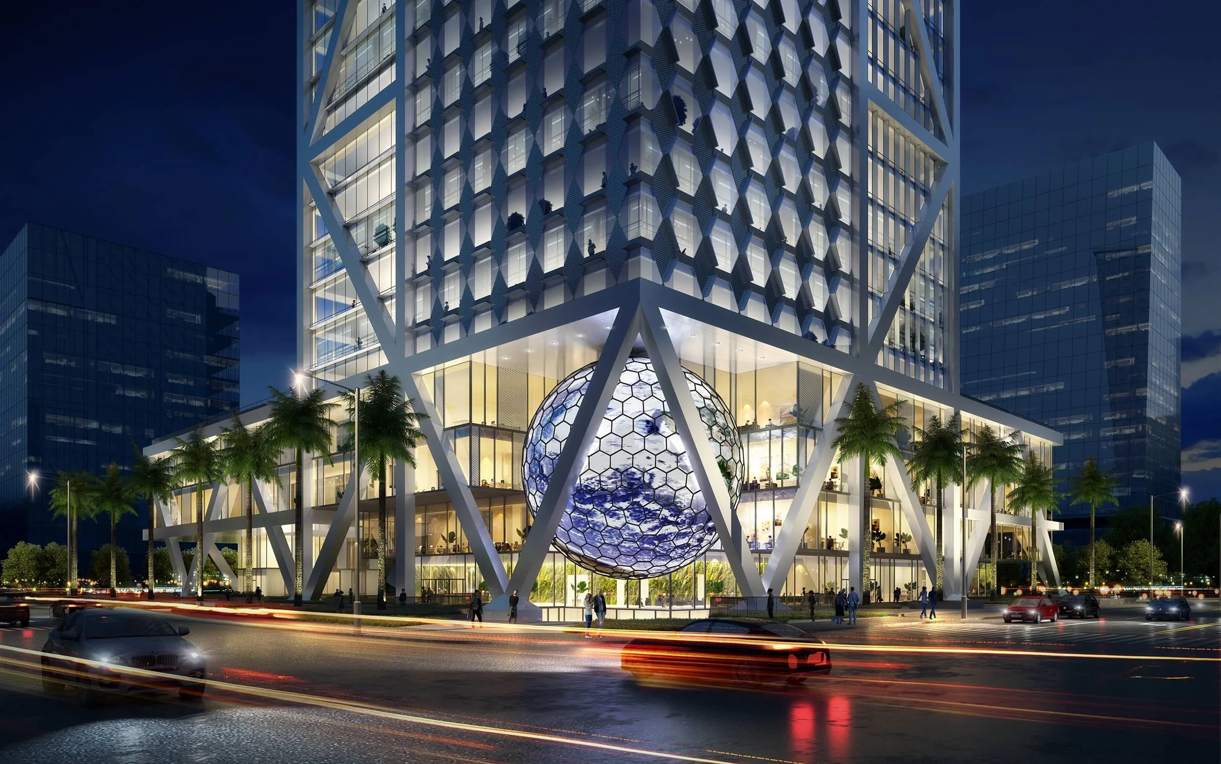 Night view of a modern high-rise building with a large geodesic sphere at the base, surrounded by palm trees and traffic on the street.