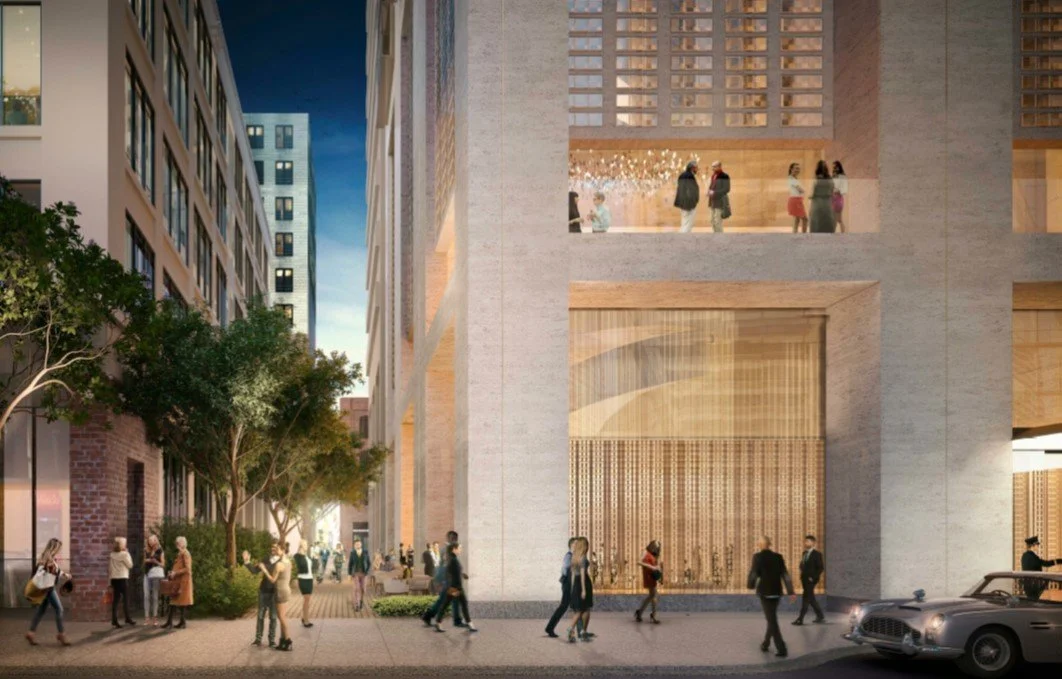 City street scene at dusk with people walking, trees, and a modern building with large windows and wooden accents.