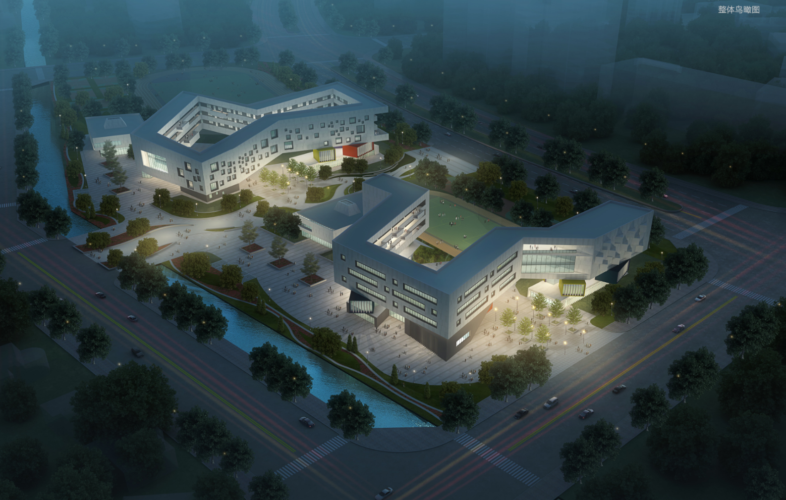 Aerial view of a modern, angular educational or institutional complex at night, illuminated with outdoor lighting, featuring multiple interconnected buildings, a courtyard, surrounding trees, and a nearby canal, with streets and traffic in the backgr