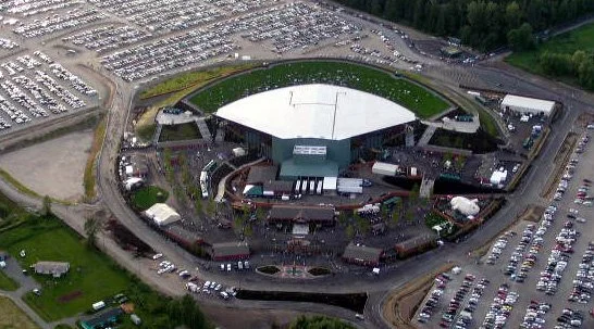 Aerial view of a large outdoor sports arena with surrounding parking lots and roads.