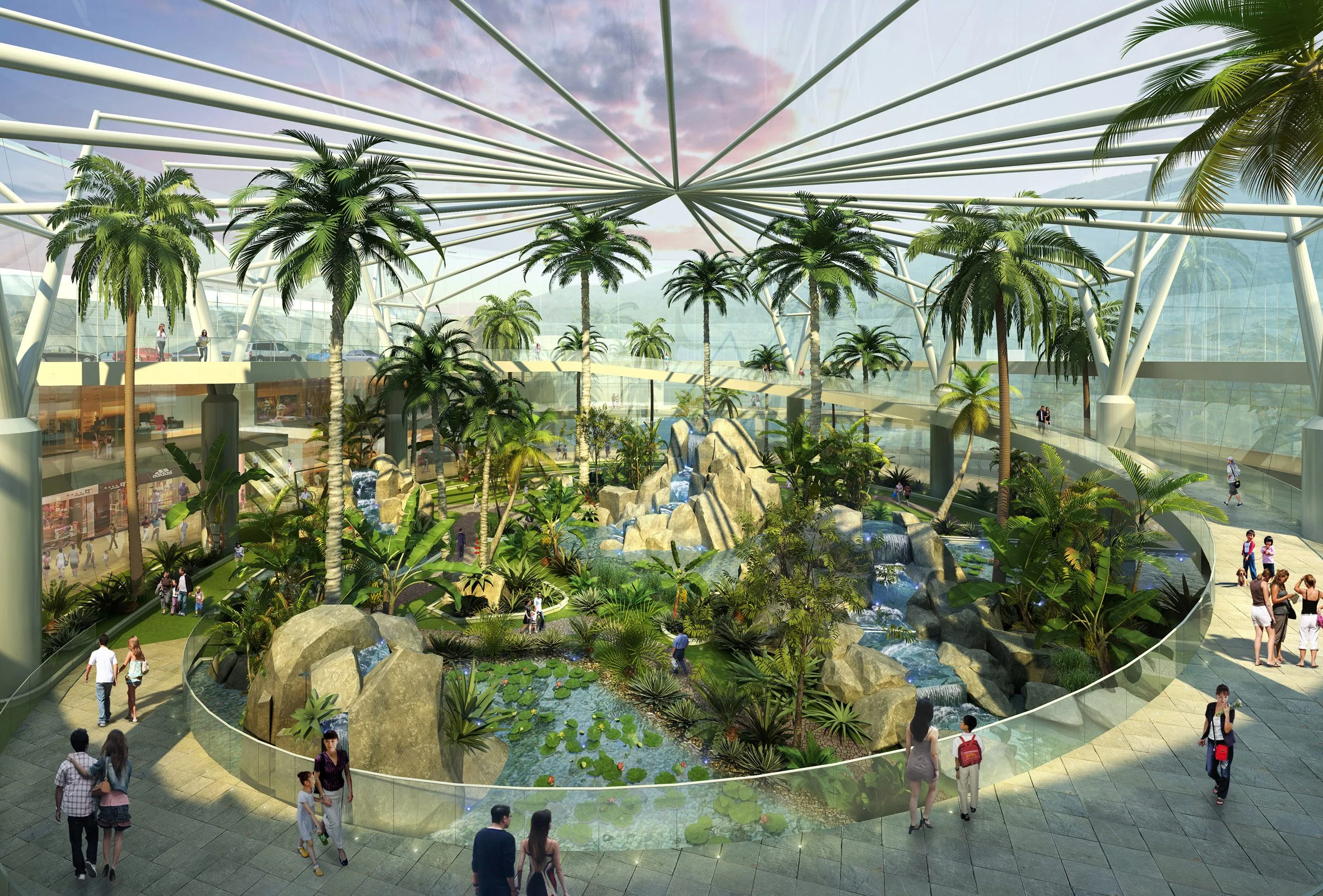 Indoor tropical garden with palm trees, waterfalls, and a pond, inside a modern glass building with people walking around.