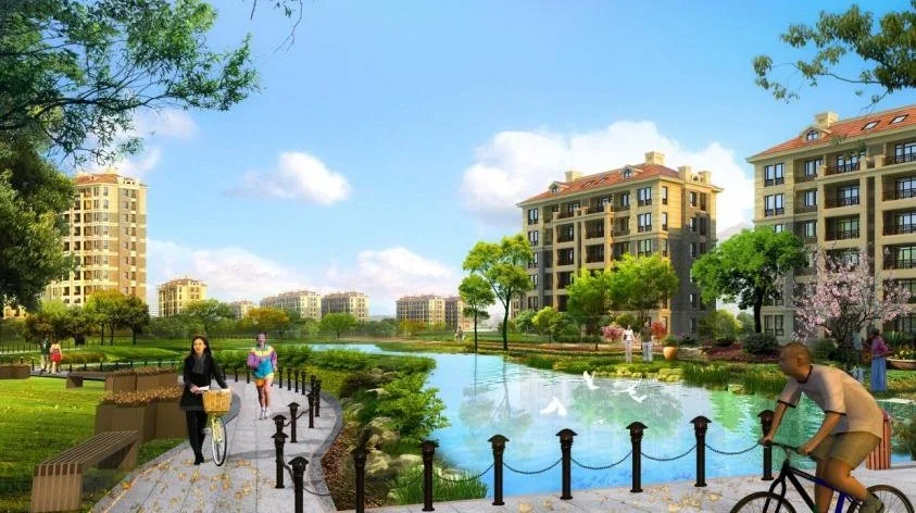 A vibrant residential complex with multi-story buildings, a water body, walking paths, people biking, and lush green trees under a blue sky.