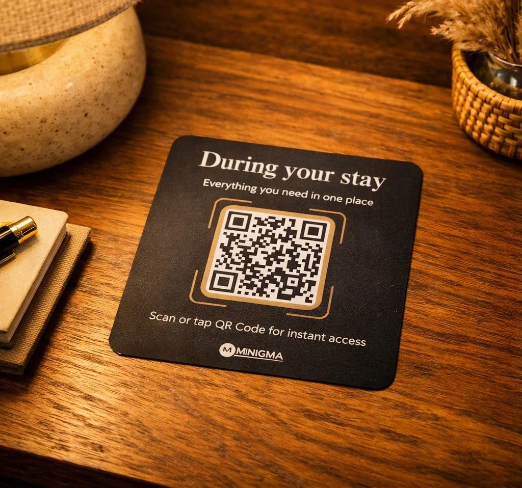 Minigma branded guest information card on a wooden table, providing access to digital hotel information and guest services.