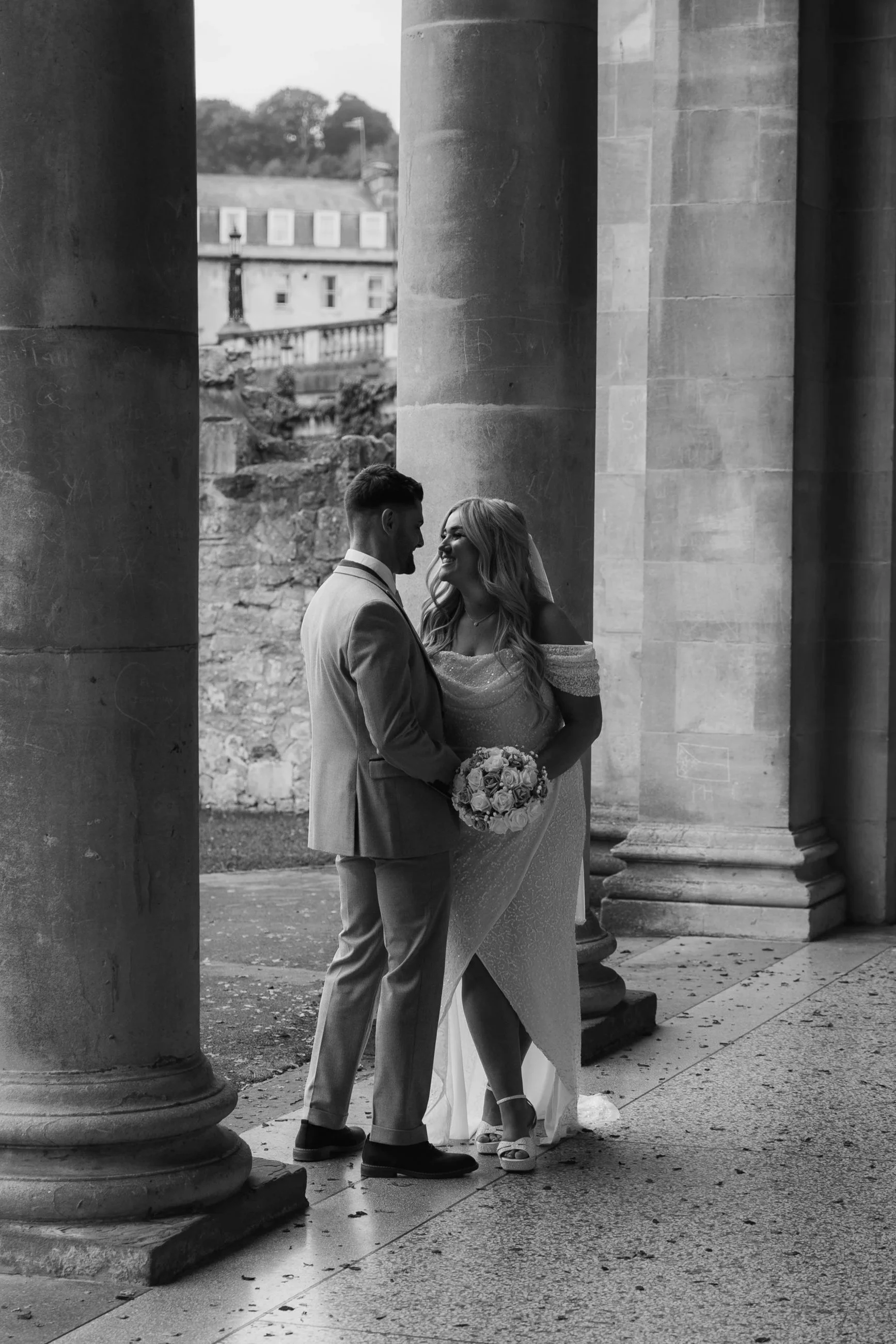 A couple taking a movement on their wedding day in Bath at Parade Gardens