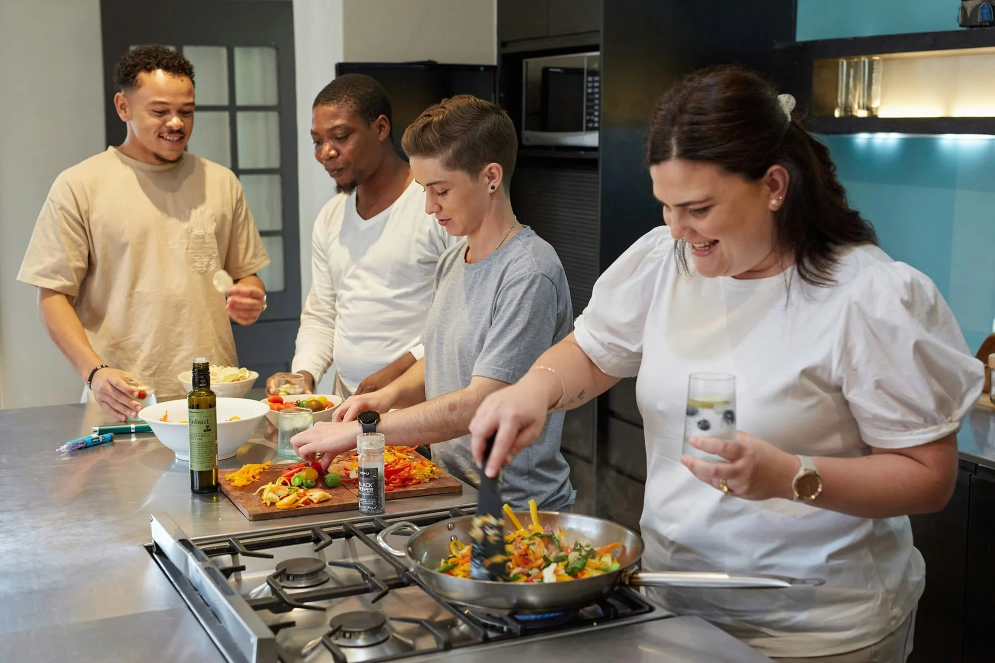 Residents at a cooking class, preparing food in a modern kitchen.