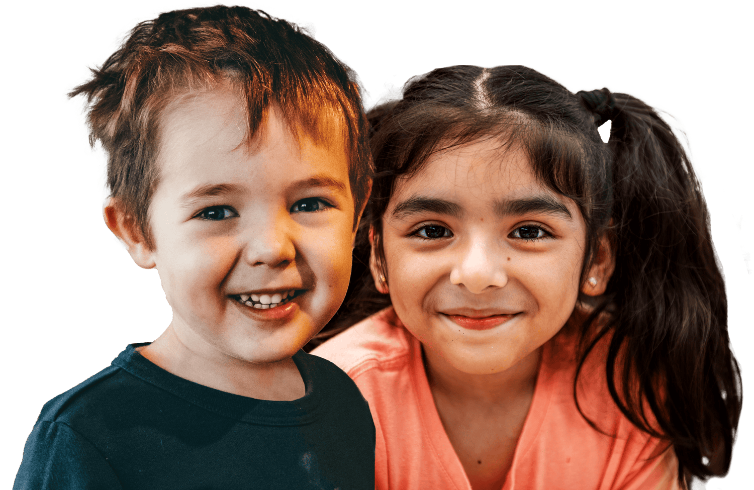 Close-up of a young boy and girl smiling.