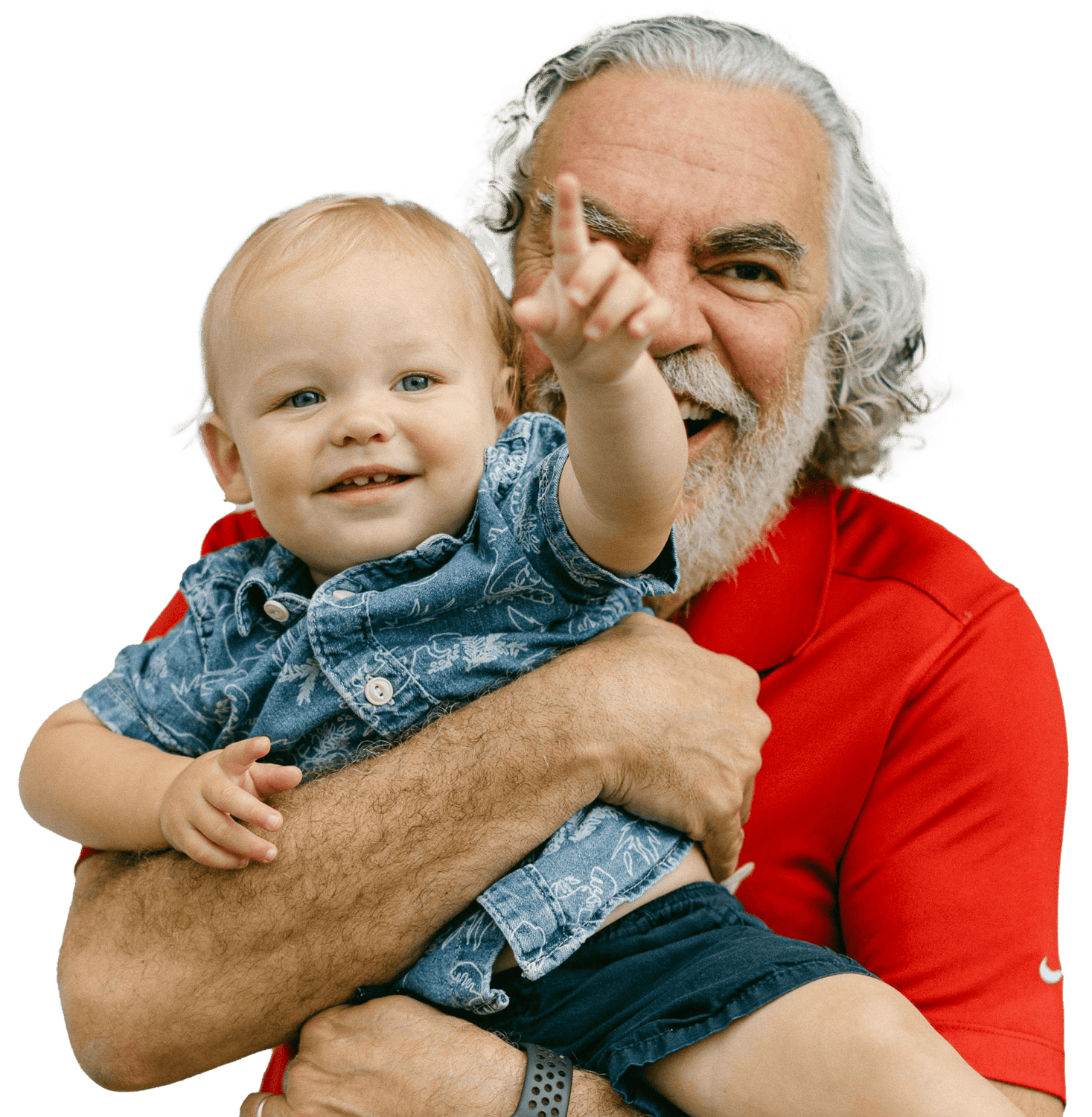 A smiling grandfather holds his happy baby grandson who is pointing at the camera.