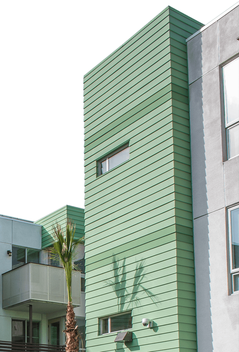 Arbor Green: a modern multi-story building with green siding, white walls, and palm trees reflecting on window
