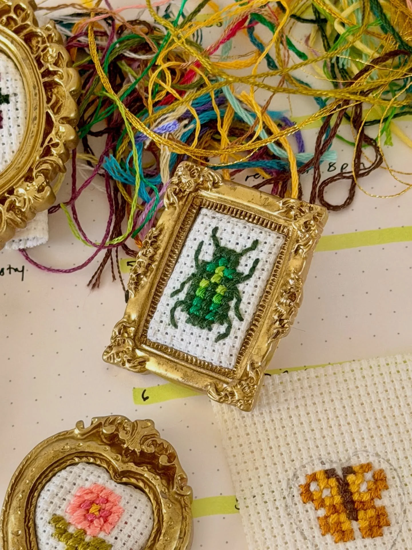 mini cross stitch frames 🪡✨

just doing my part to add a touch of whimsy to the world 🫡 

my first efforts at cross stitch!! what do you think? it&rsquo;s the inevitable result of finding a huge roll of aida cloth at my grandmothers house, and havi