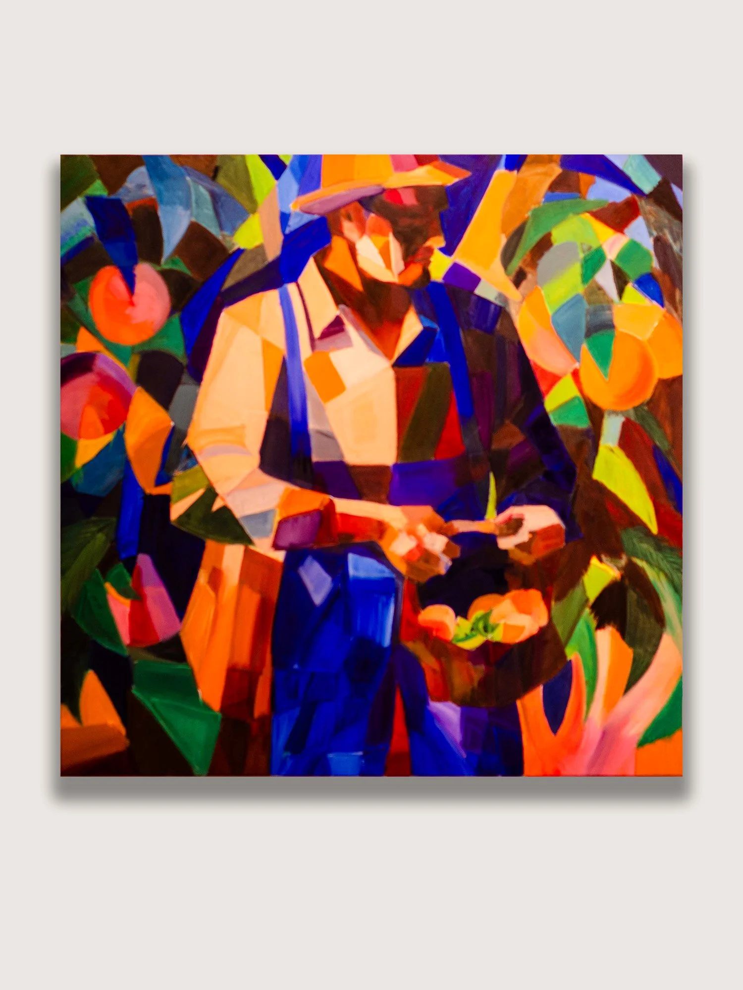Cubist oil painting titled Peach Farmer by Western Colorado artist Farron Khan depicting a fragmented agricultural worker through layered geometric forms and warm earth tones to explore labor, identity, and regional landscape.
