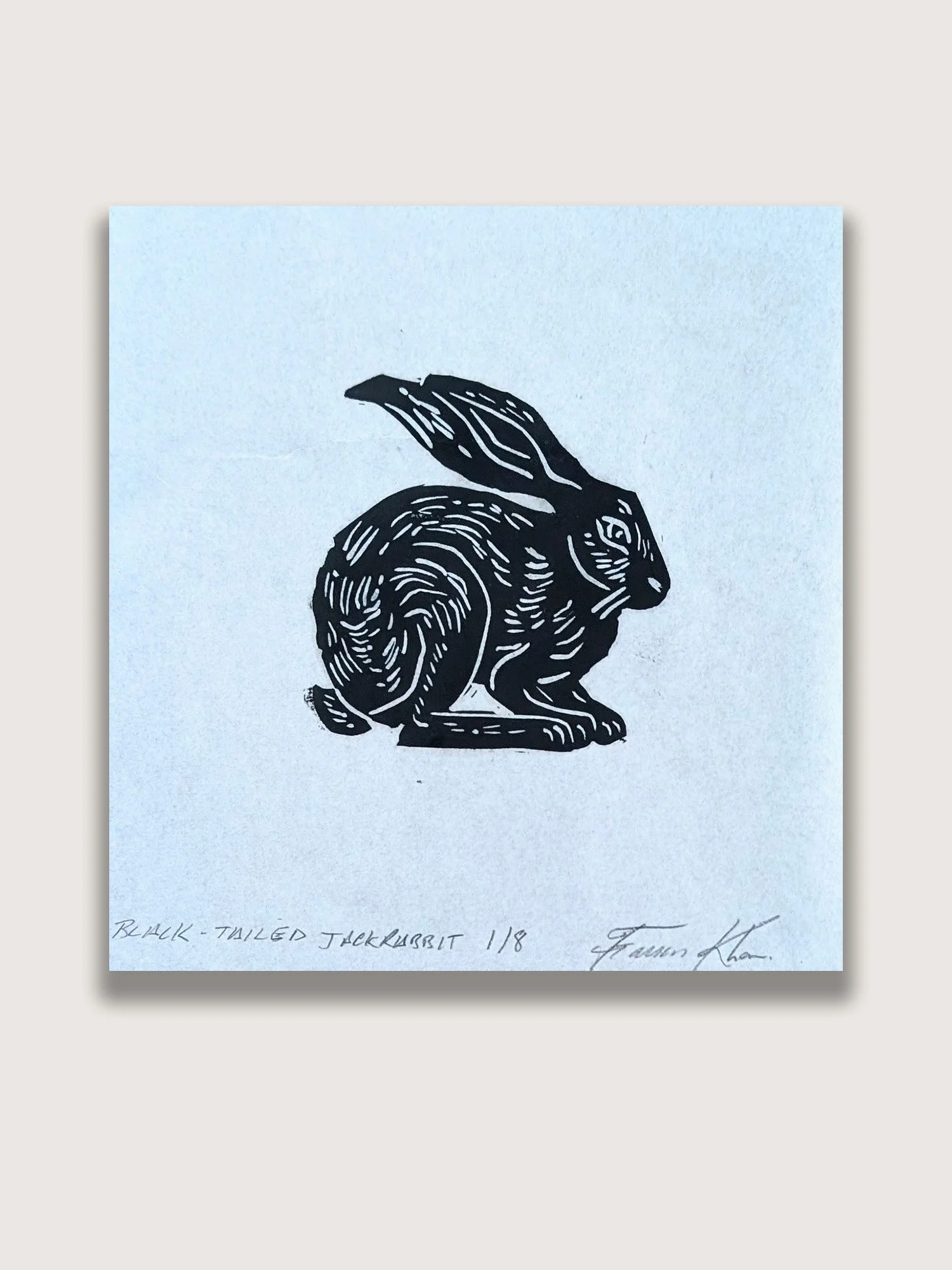 Minimalist linocut print depicting a black-tailed jackrabbit in profile. Nature-inspired printmaking artwork exploring regional wildlife, adaptation, and the beauty of desert ecosystems.