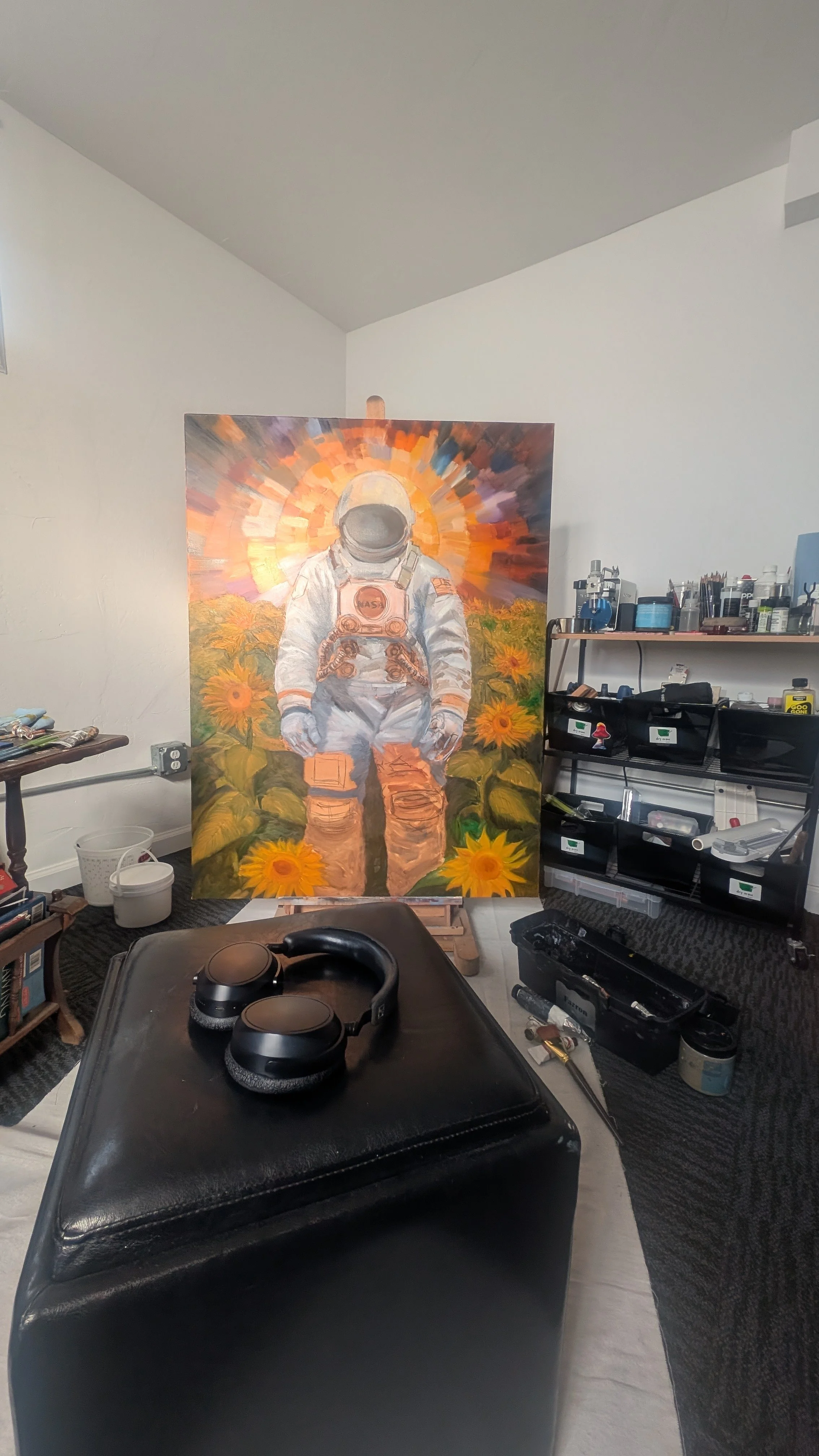 A colorful painting of an astronaut walking through a field of sunflowers with a vibrant, abstract sunset or sunrise background.