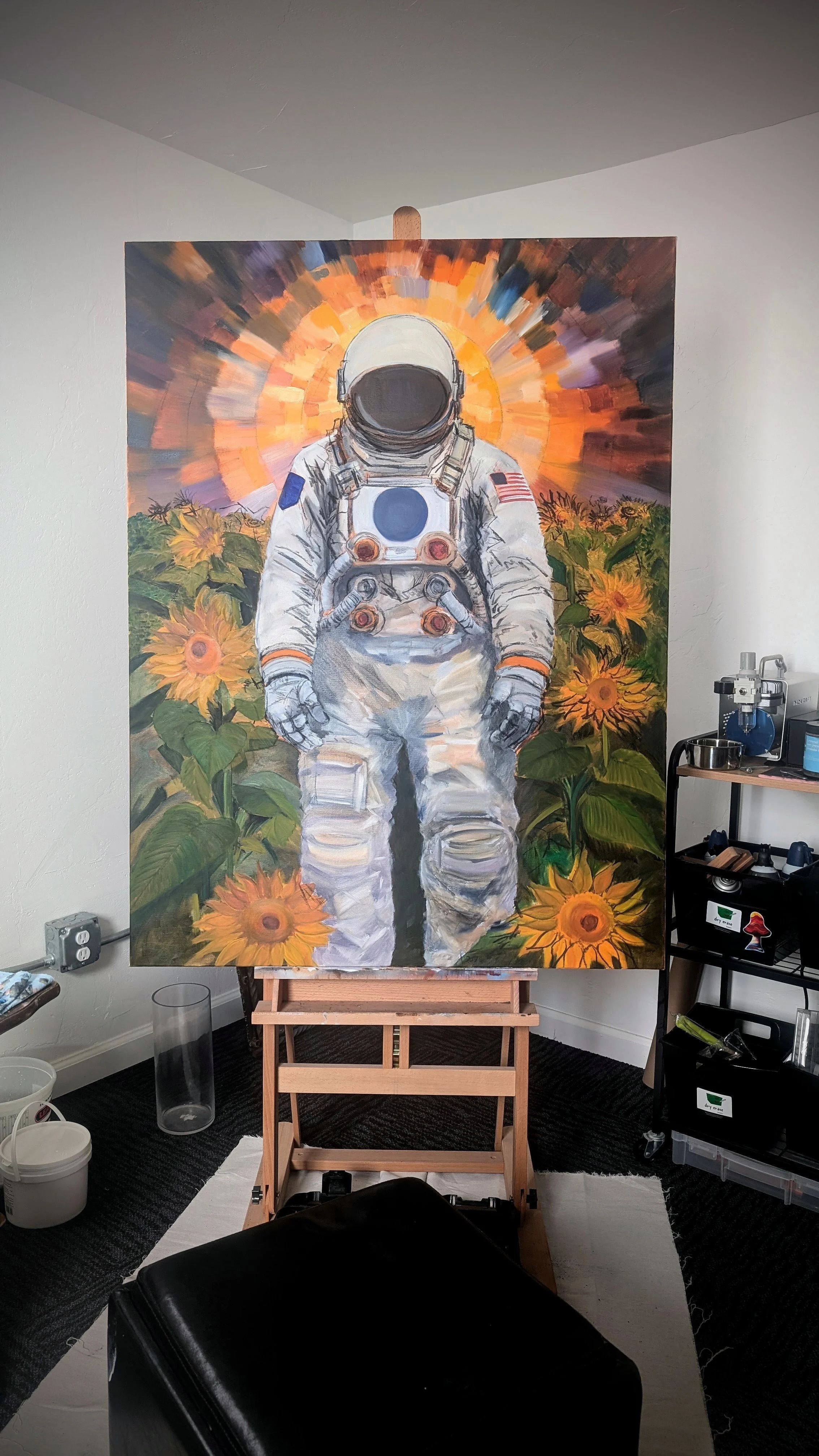 Painting of an astronaut in a spacesuit standing in a field of sunflowers with a colorful, radiant background.