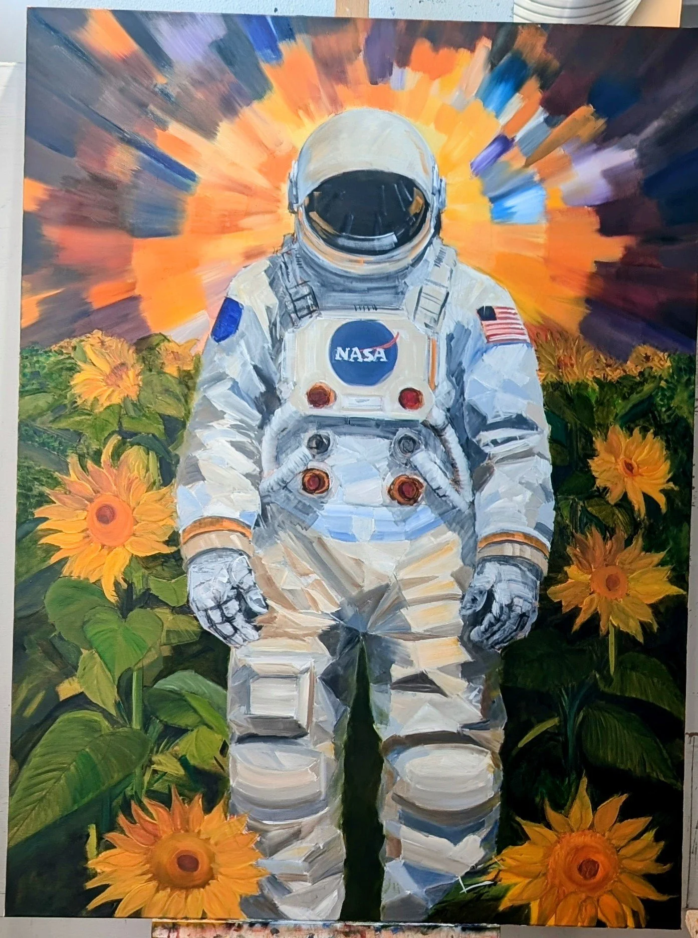 Painting of an astronaut standing among orange sunflowers, with a colorful, radiant background resembling a sunset or sunrise.