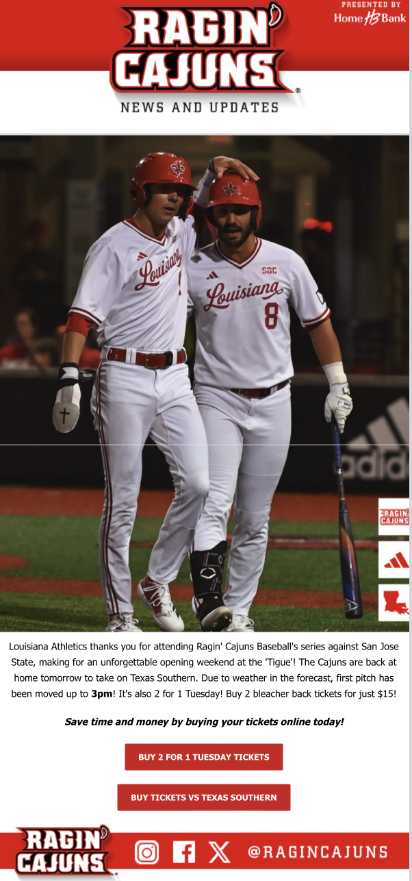 Two baseball players in white Louisiana Cajuns uniforms and red helmets. One player has an arm around the other's shoulder, both appear to be celebrating on the field.