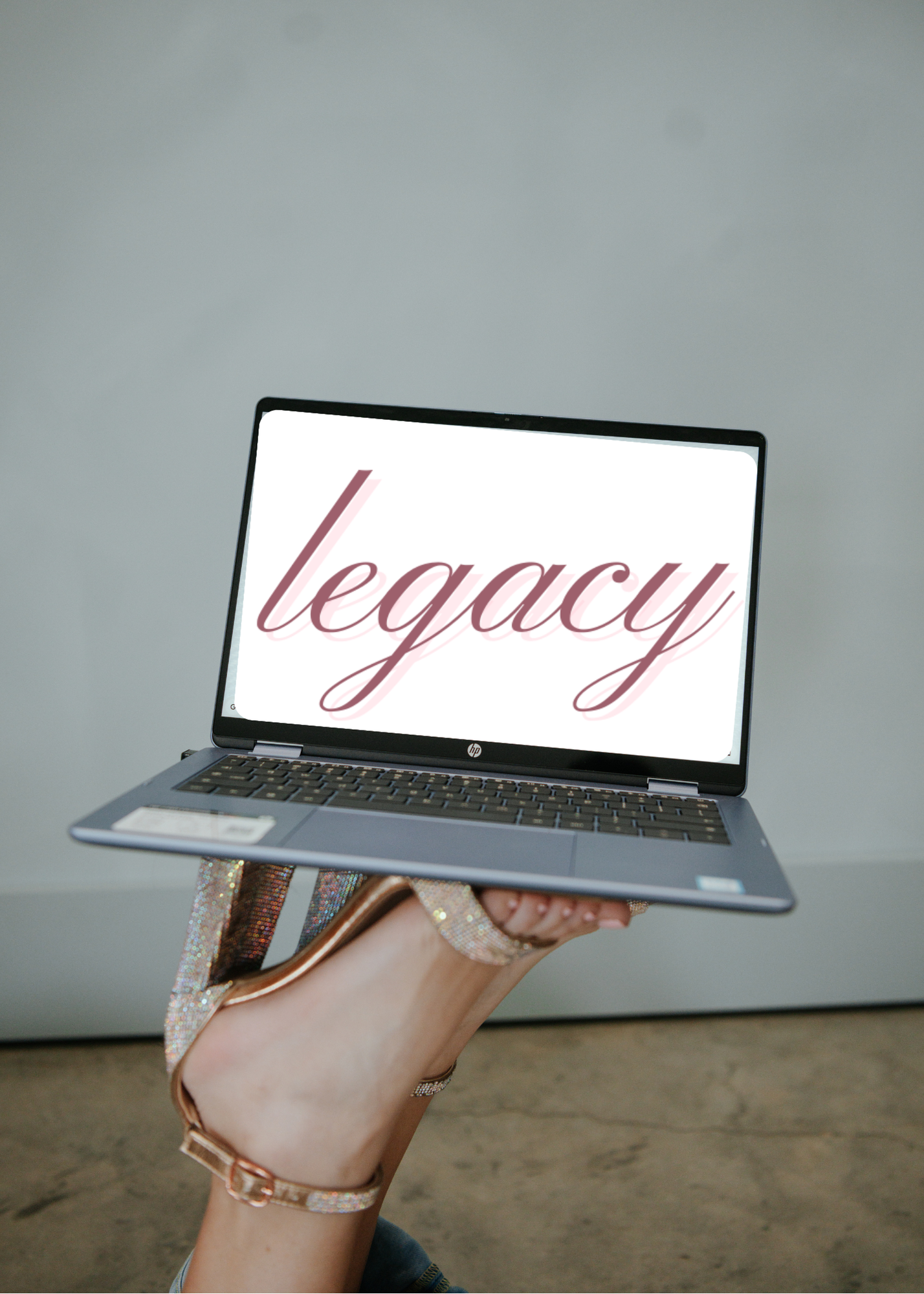 The word 'legacy' written in pink cursive script on a black background.