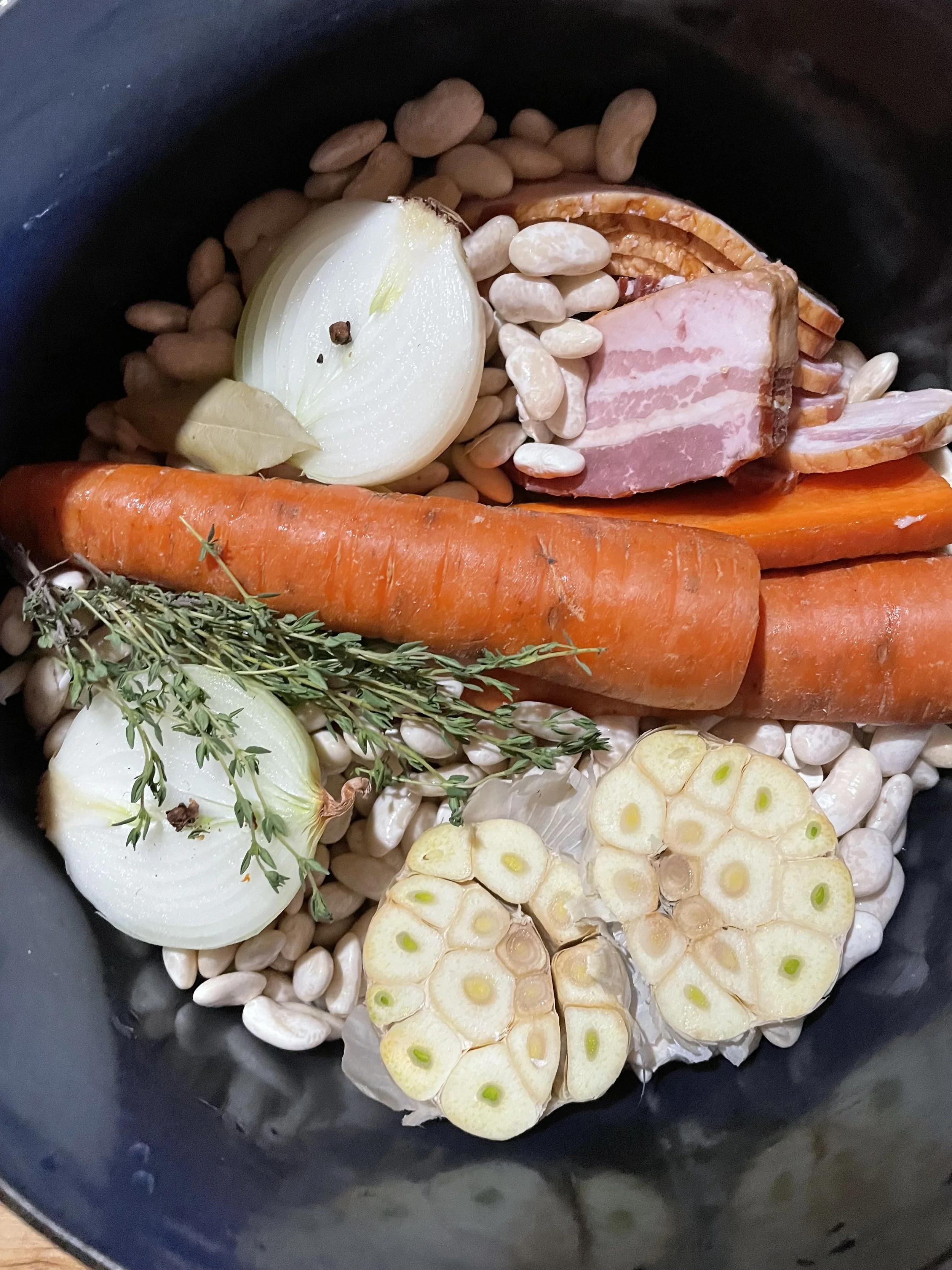 A pot filled with uncooked soup ingredients
